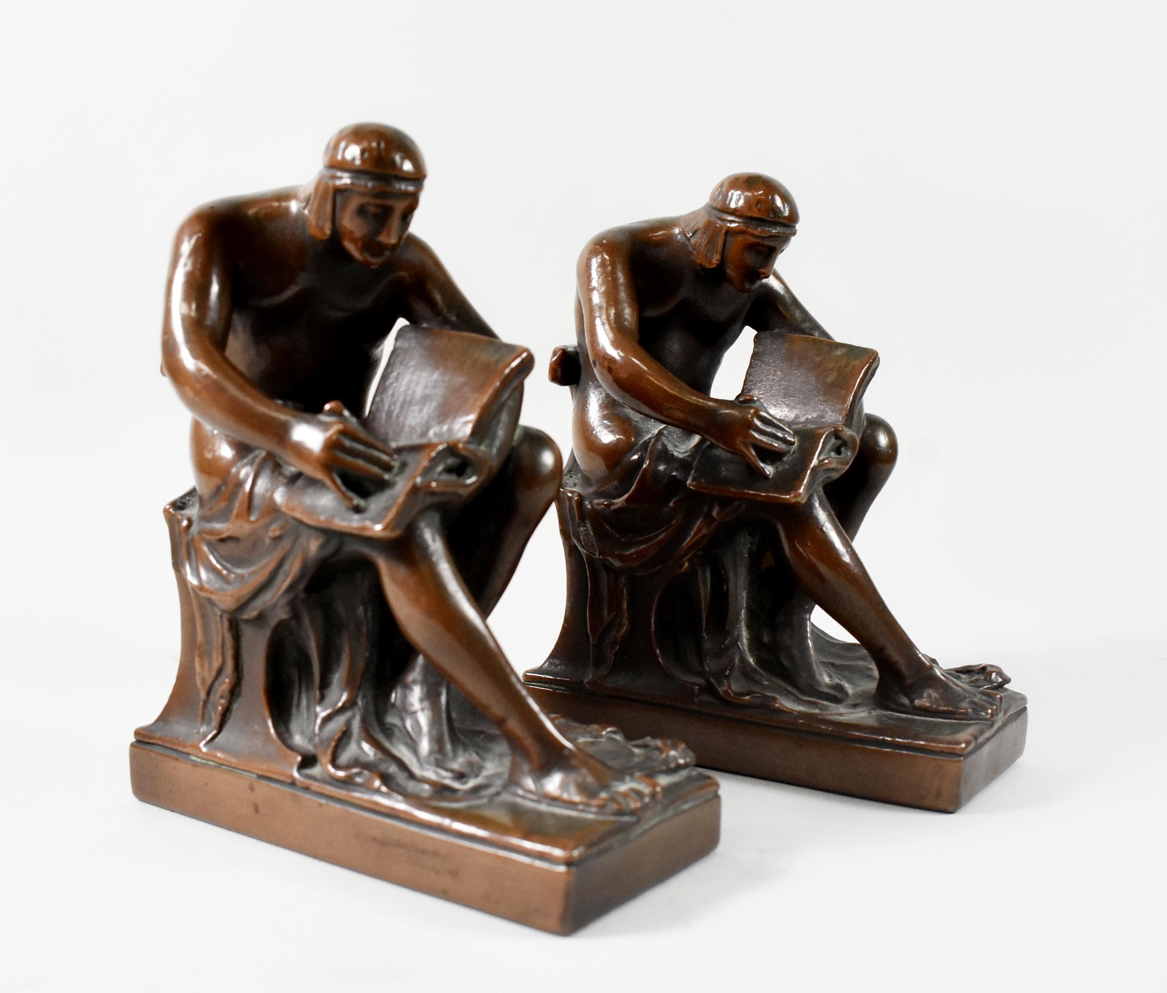 Pompeiian Bronze Co bronze clad figural bookends circa 1920's. Depiction of a seated man with a book.