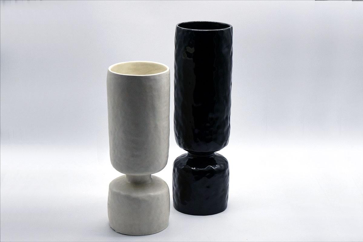 Pair of ceramic vases design Pompeo Pianezzola for Zanolli ceramics.
Nove-Vicenza 1970s.
Cylindrical in shape with bottleneck at base,one in matt white ceramic and one in polished black ceramic with handmade colombino work.
Label with mark on the