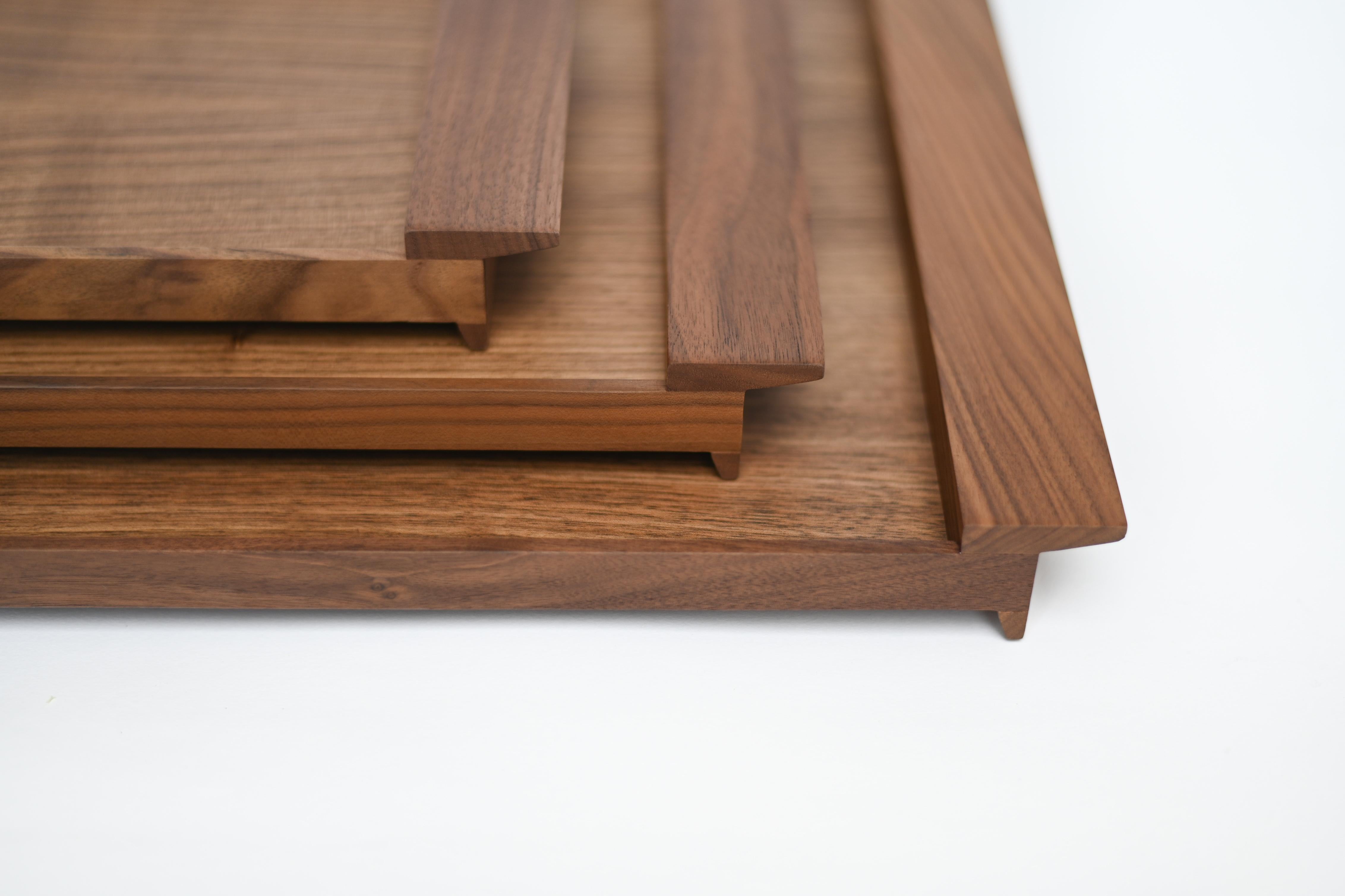 These wooden trays in maple or walnut are all about joinery details. The design carries a Portuguese signature, as well as Scandinavian and Japanese influences. Ponte means bridge in Portuguese – a set of trays that support, highlight and transport