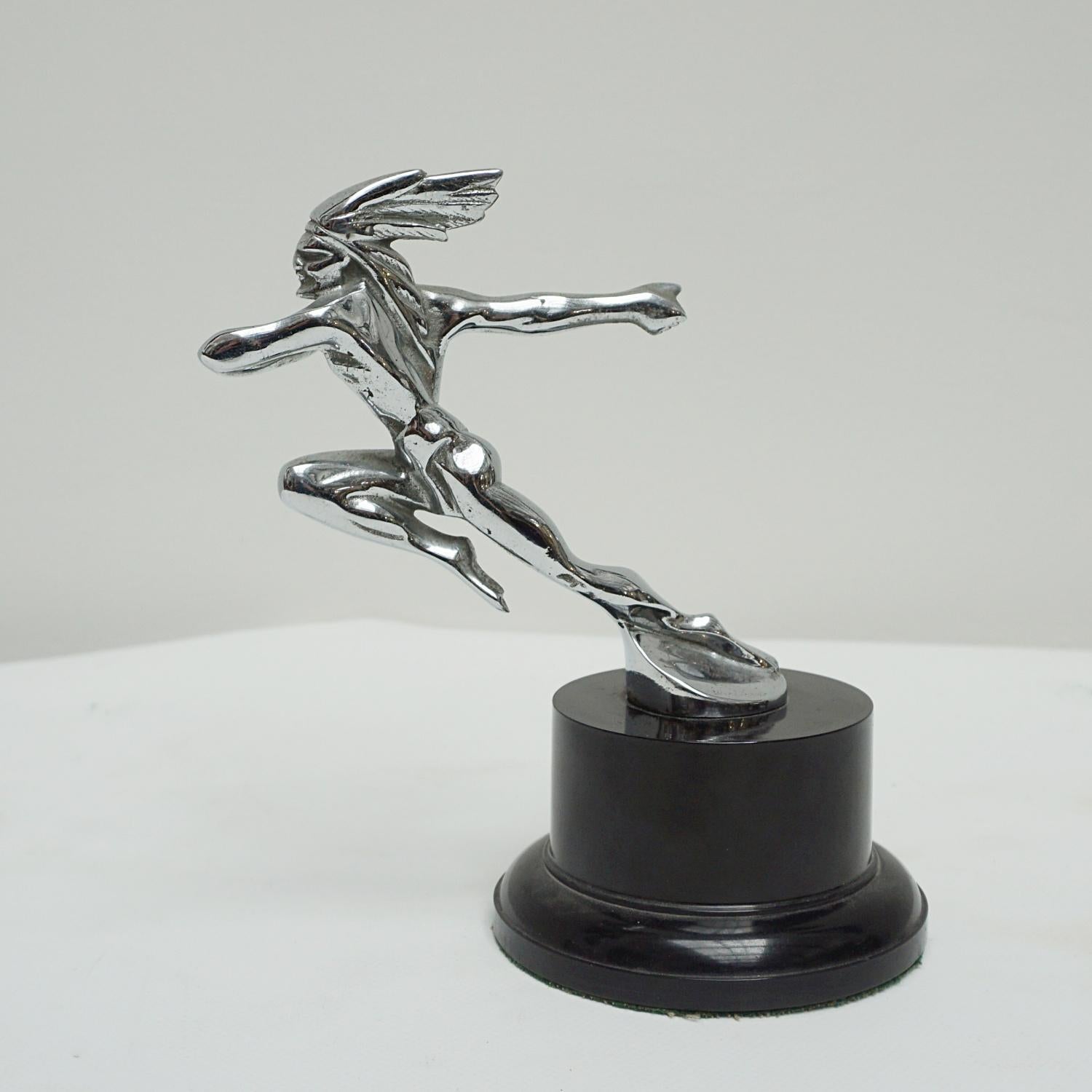 An Art Deco nickel plated Pontiac car mascot of a running Native American Chief. Set over circular wooden base. 

Dimensions: H 19cm W 19cm D 10cm

Origin: American

Date: circa 1935

Item Number: 604231.