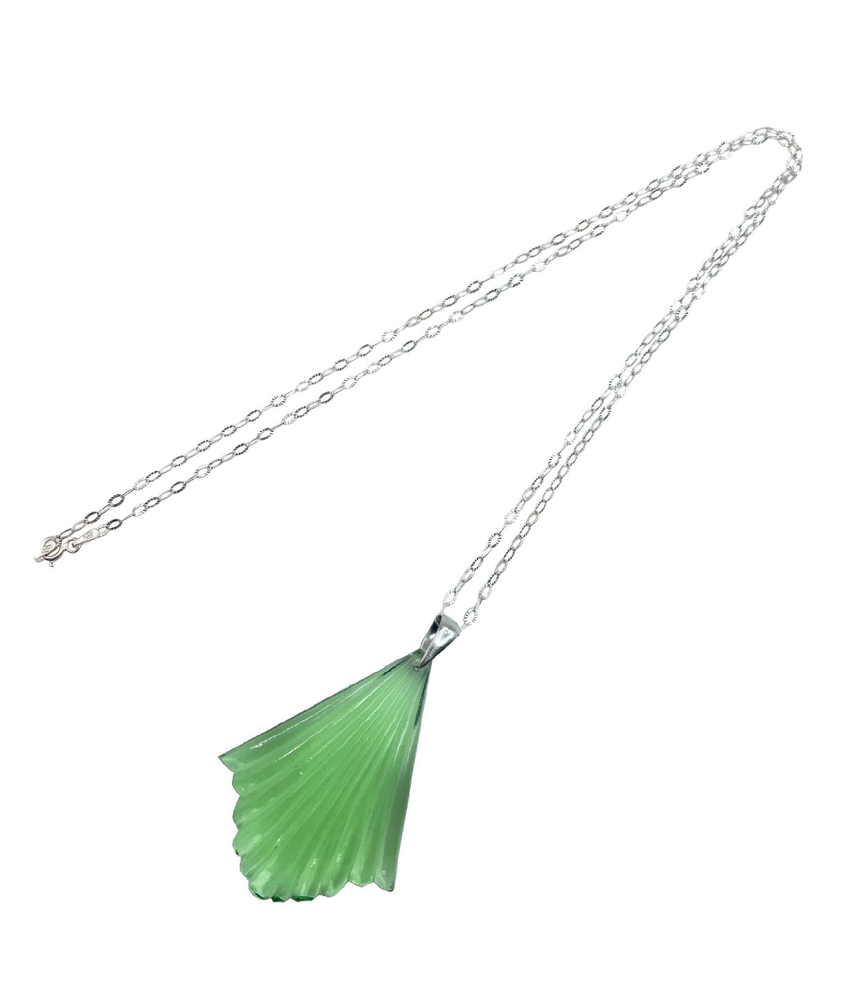 This Art Deco molded transparent green glass fan pendant is from 1930s Czech Republic. 

A tribute to the bygone era of the 30's, the Deco fan symbolized power amongst pharaohs and royalty. This classic fan pattern is found in Art Deco architecture,