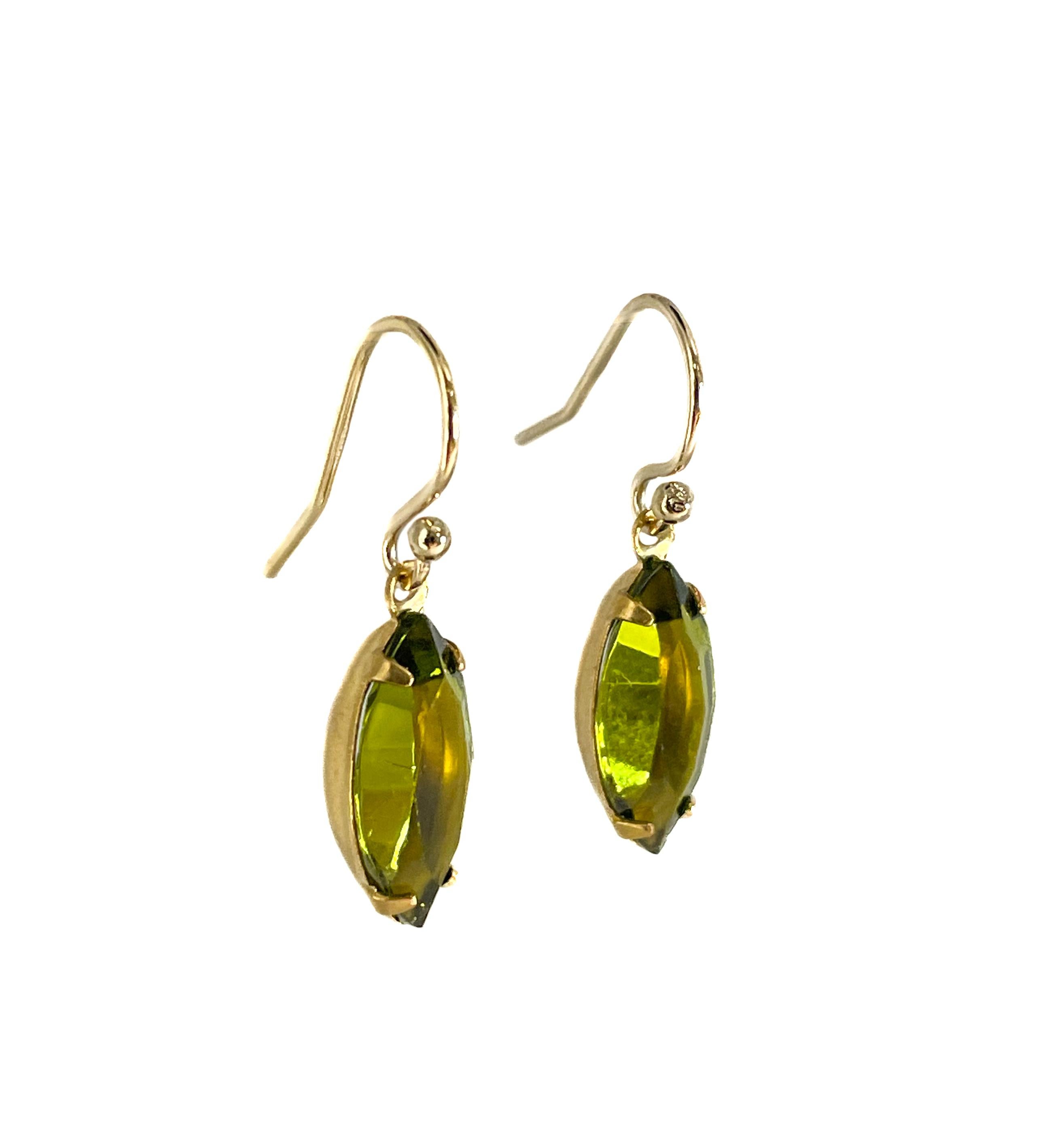 These delicate and elegant drop earrings are made from vintage crystal from Czech Republic. The crystal is made to resemble olivine. 

Each crystal drop measures 15 x 7 mm. They are set in an original brass prong setting. They are hanging from a