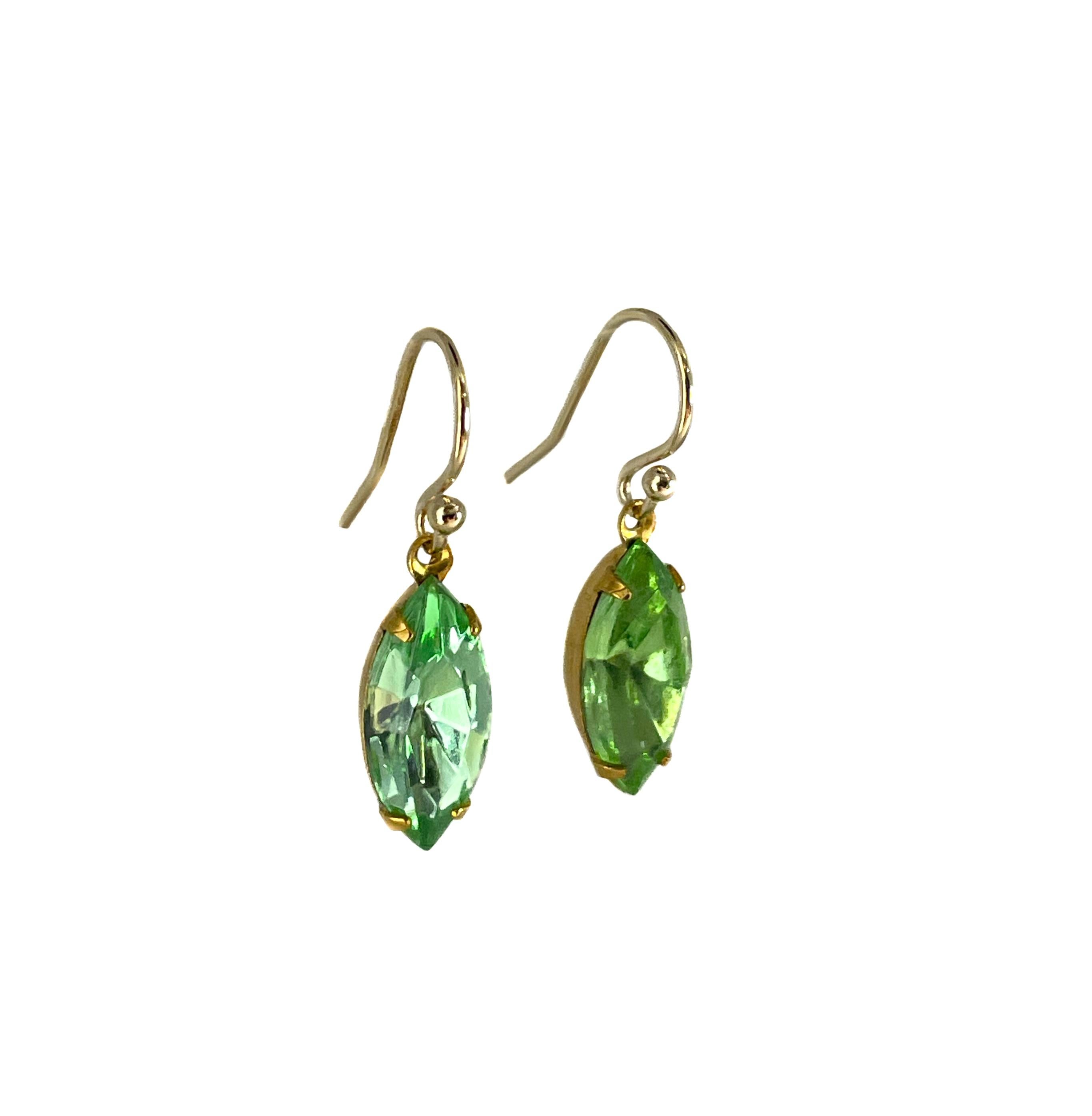 These delicate and elegant drop earrings are made from vintage crystal from Czech Republic. The crystal is made to resemble peridot. 

Each crystal drop measures 15 x 7 mm. They are set in an original brass prong setting. They are hanging from a