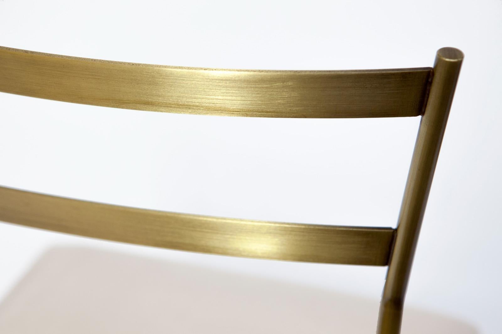 This skillfully hand-crafted Pontina chair will make a distinctive statement in a sophisticated contemporary interior with its understated elegance. Showcasing a minimalist silhouette, that is entirely handcrafted in satin brass finished iron with