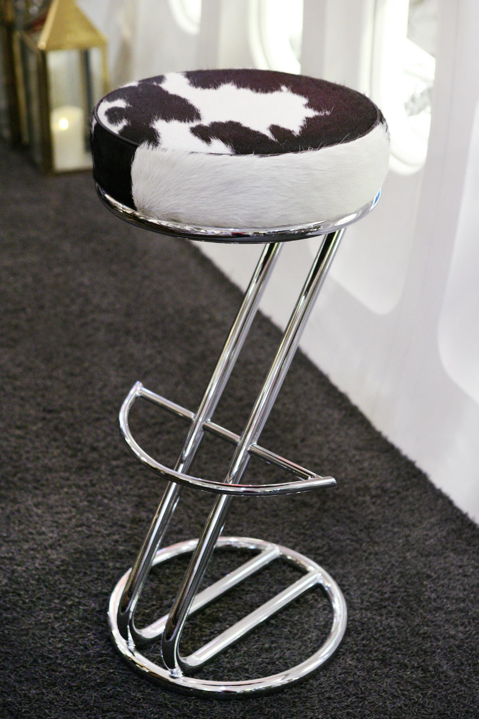 Bar Stool Pony 1 upholstered and covered with natural 
pony on polished stainless steel base. With footrest.
 