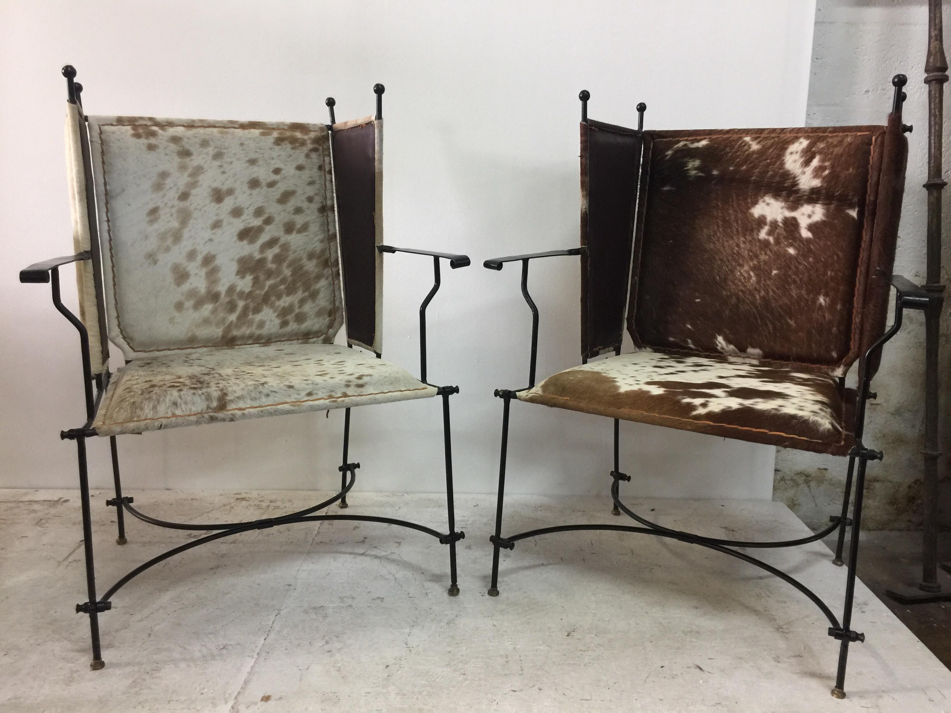 These natural pony hide covered iron armchairs are solid and classically designed. Ball finials accents and very chic!