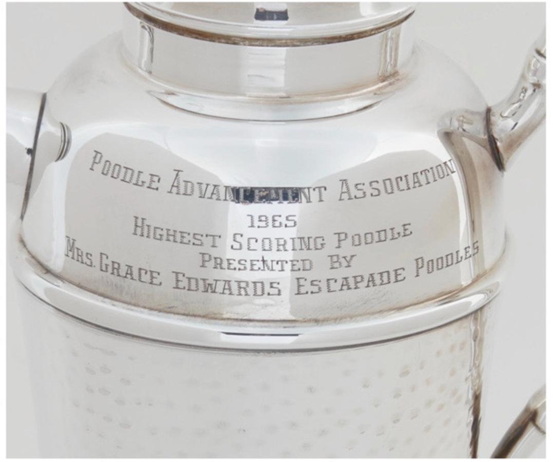 This is a traditional mid-century silver plate cocktail shaker---with a unique engraved inscription of being awarded as a Poodle Competition Trophy.
This is the perfect gift for the poodle lover/fanatic. The shaker is in very good to excellent
