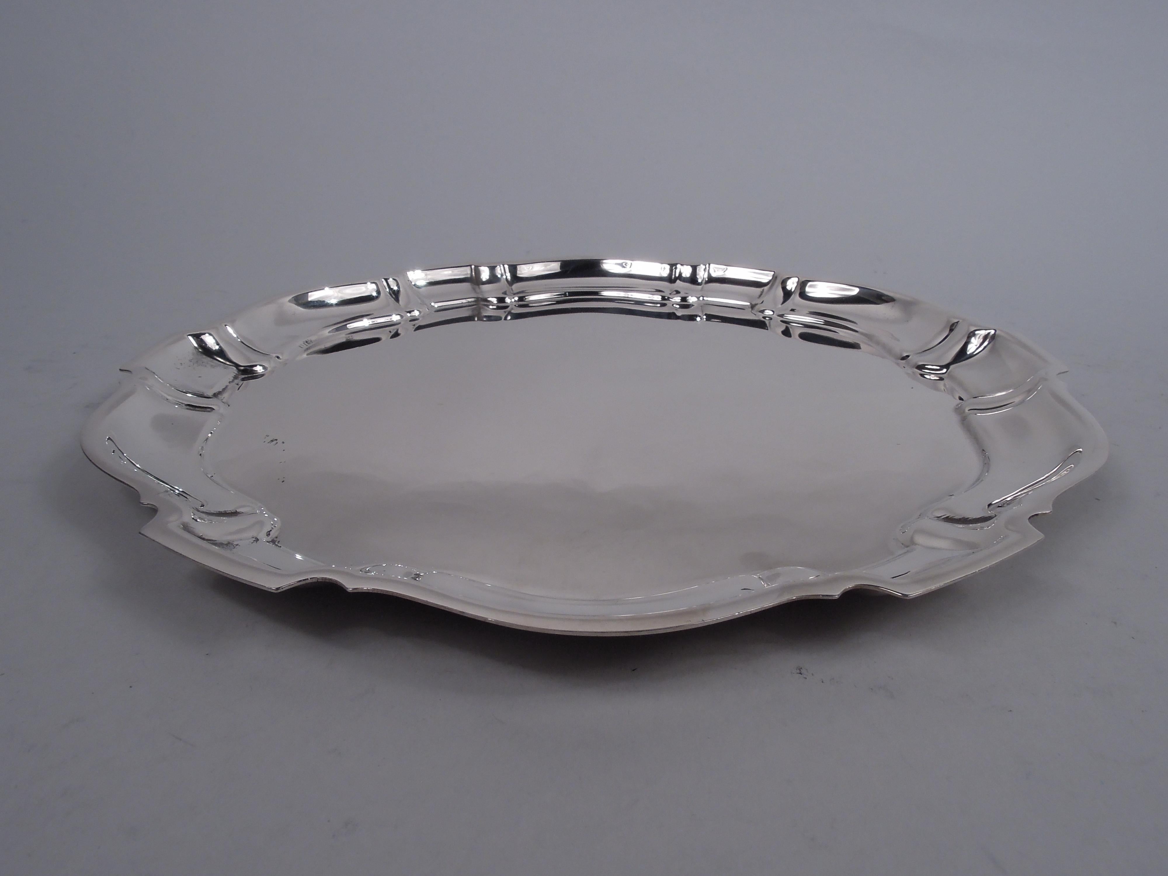Chippendale sterling silver tray. Made by Poole in in Taunton, Mass. Round with flat and crisp Georgian-style curvilinear piecrust rim. Fully marked including maker’s stamp, pattern name, and no. 90. Weight: 15 troy ounces. 