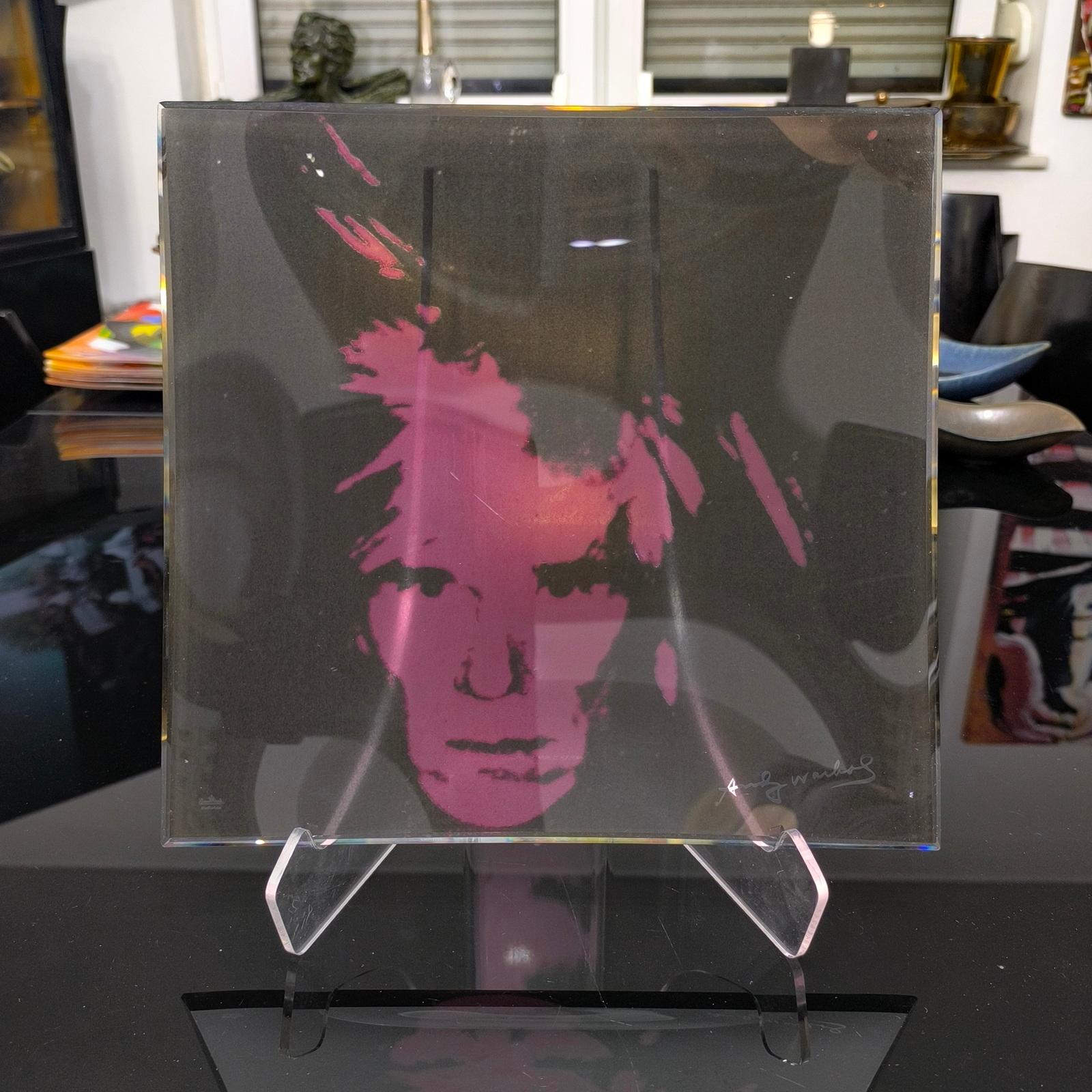 Self-portrait Curved Glass Tray, designed by the iconic artist Andy Warhol, edited by Rosenthal Studio Line.
This glass tray is both a practical accessory and a captivating piece of contemporary art. Squared in shape, the tray has clean lines and a
