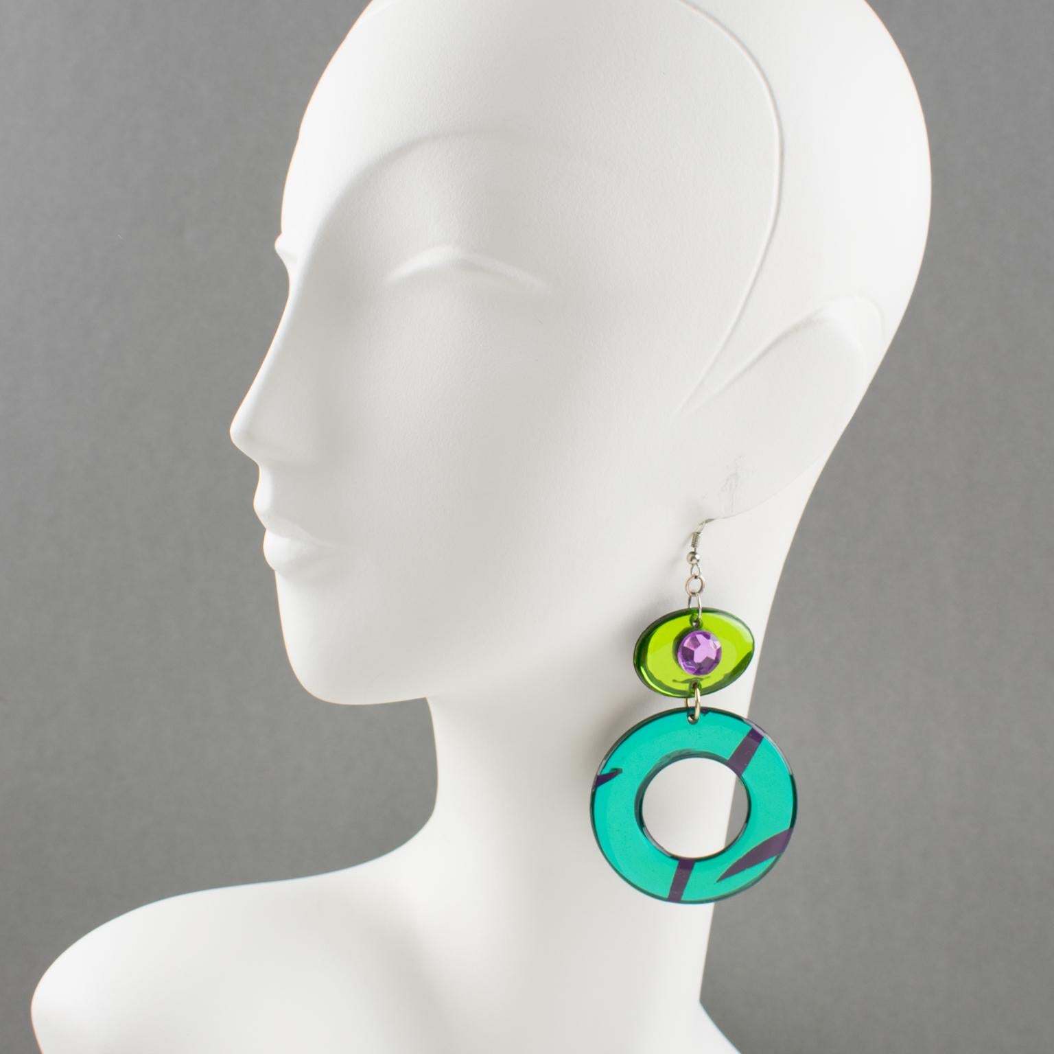 These adorable Italian designer studio Lucite or Resin dangling pierced earrings feature an oversized chandelier design with ovoid and donut shapes in emerald green and apple green colors with a mirror effect and textured pattern. The earrings are
