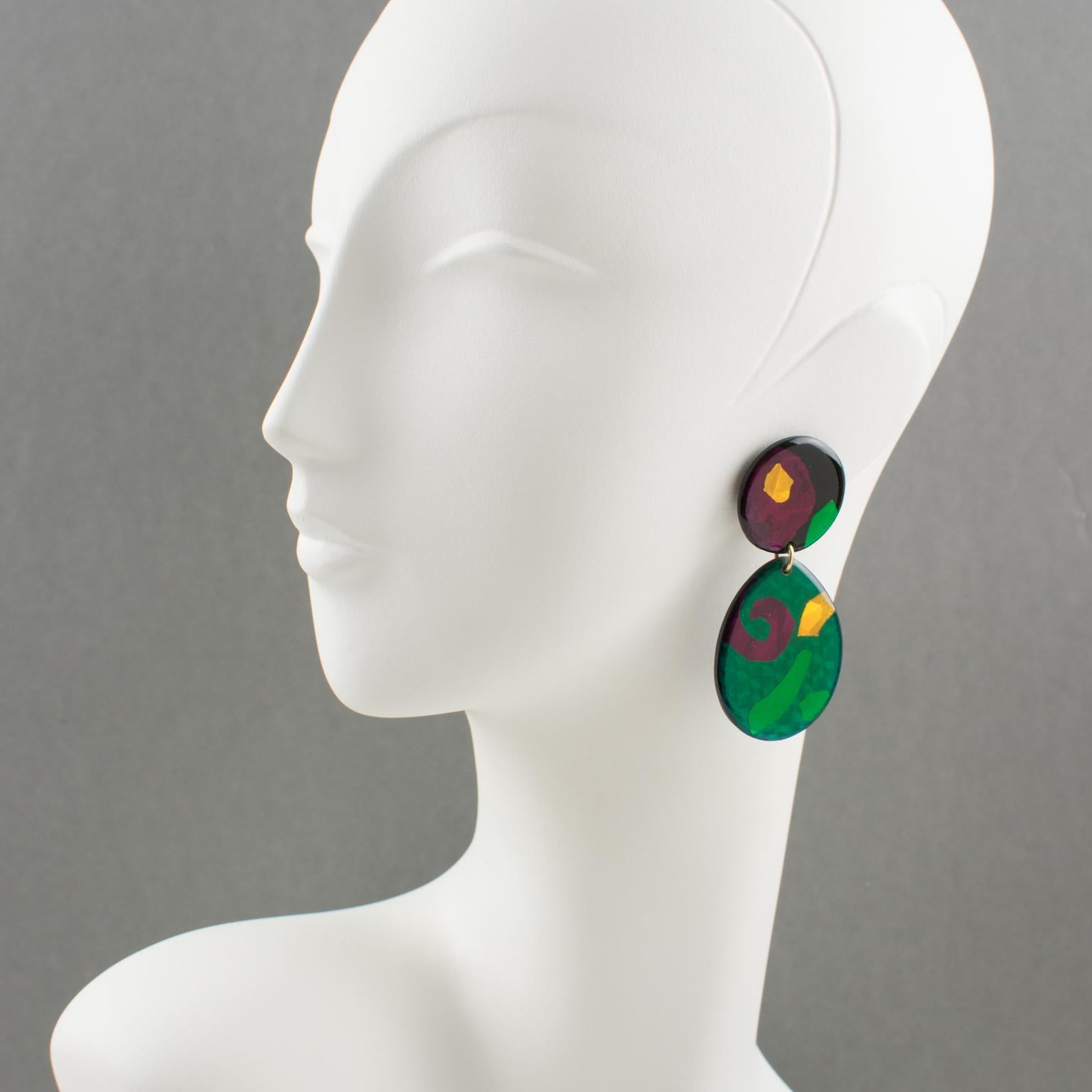 Lovely Lucite dangling clip-on earrings. Geometric design with round and drop shape in emerald green, hot pink, and yellow-orange colors with mirror effect and textured pattern. Total eye-catching Pop Art statement piece. No visible maker's