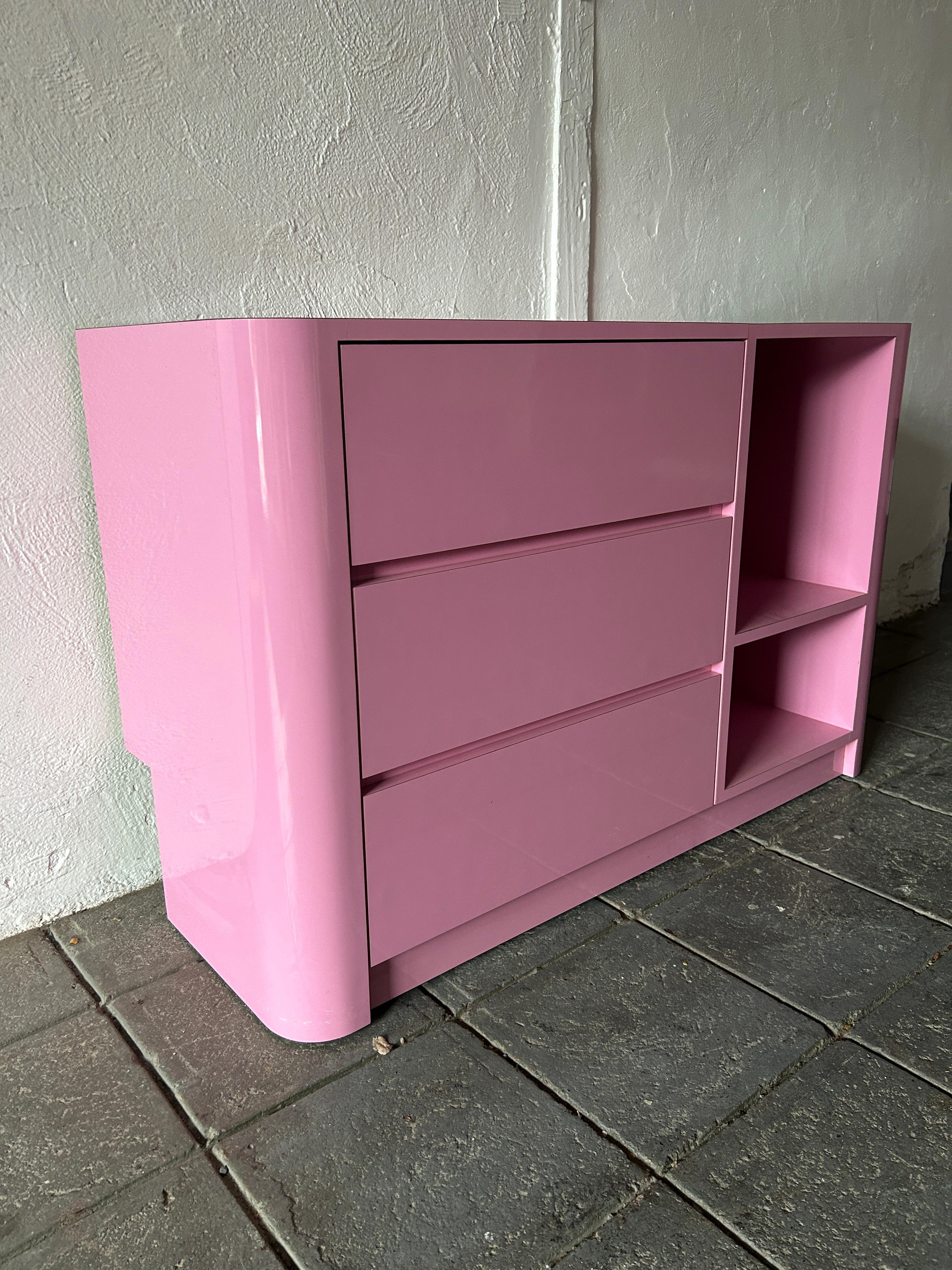 Beautiful post modern custom made bubblegum pink gloss laminate 3 drawer dresser or credenza circa 1980. Very clean inside and out almost like new. Look at photos. There is (3) drawers on the left and (2) cubby shelves on the right. Great for home,