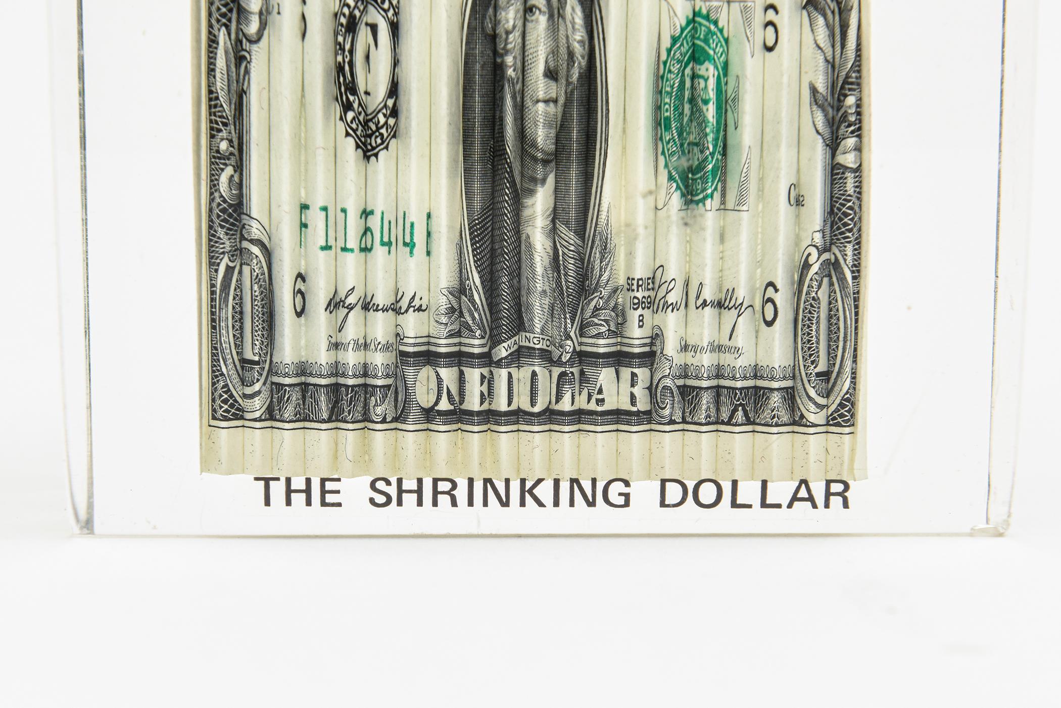 This iconic small vintage 1970s pop art lucite sculpture is called THE SHRINKING DOLLAR