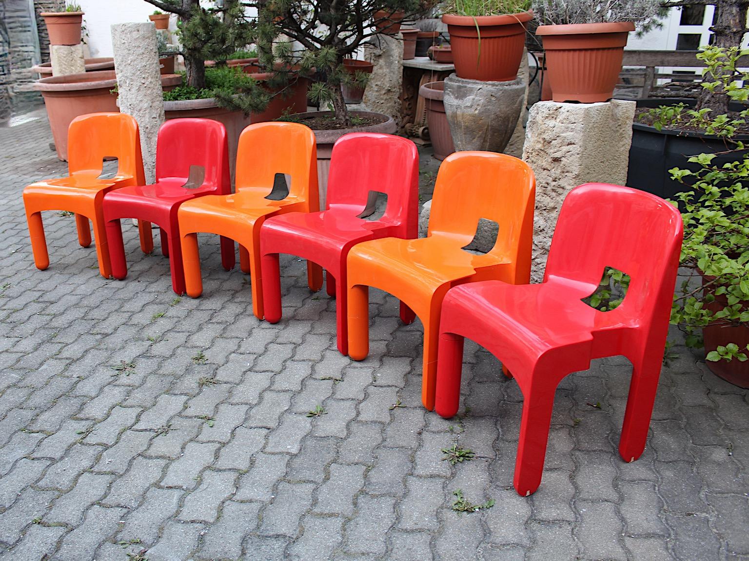 Space Age red and orange six plastic pop art vintage chairs or dining chairs model Universale designed by Joe Colombo 
1965 - 1967 and executed by Kartell, Milano.
These happy making colors like cherry red and bold orange highlights this set of six
