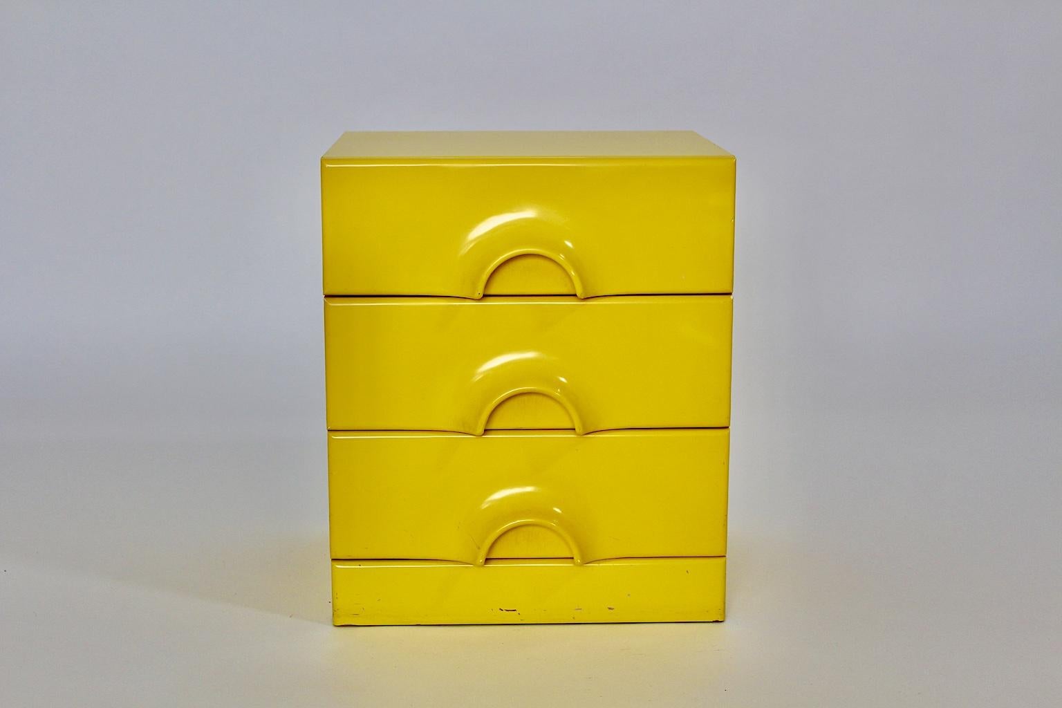 Modern Pop Art Style vintage yellow chest of drawers from plastic coated pressboard in yellow color tone circa 1970 Germany.
The body of the chest was made of pressboard while the surface was laminated with yellow plastic.
The 3 drawers show