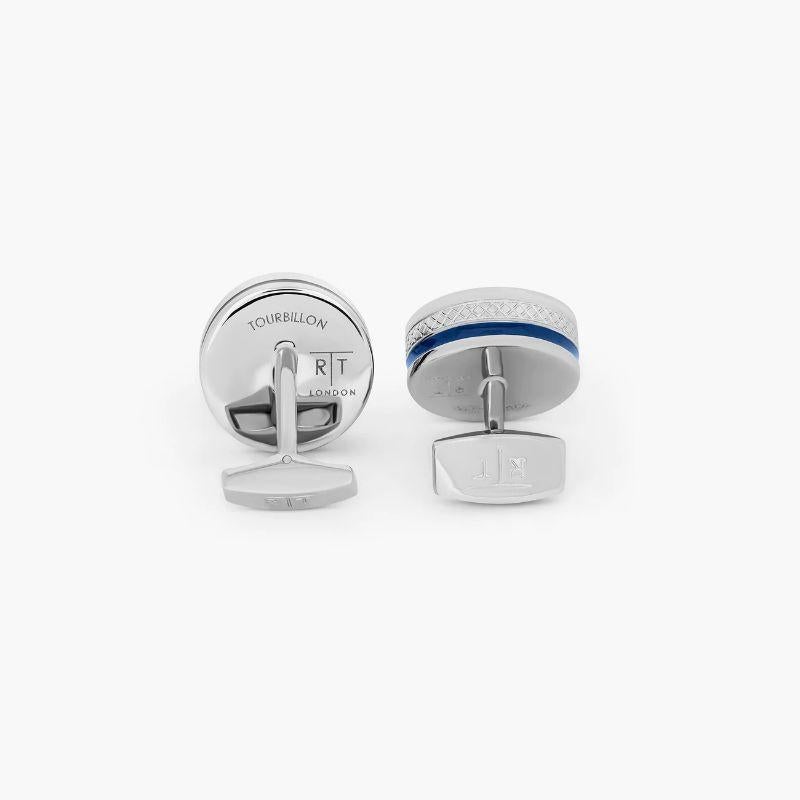 Pop Tourbillon Cufflinks with Blue Enamel in Rhodium

These cufflinks feature a small tourbillon; an oscillating wheel from part of a watch mechanism. Each one is set with 7 synthetic rubies which are crucial to keep the watch time accurate. One of