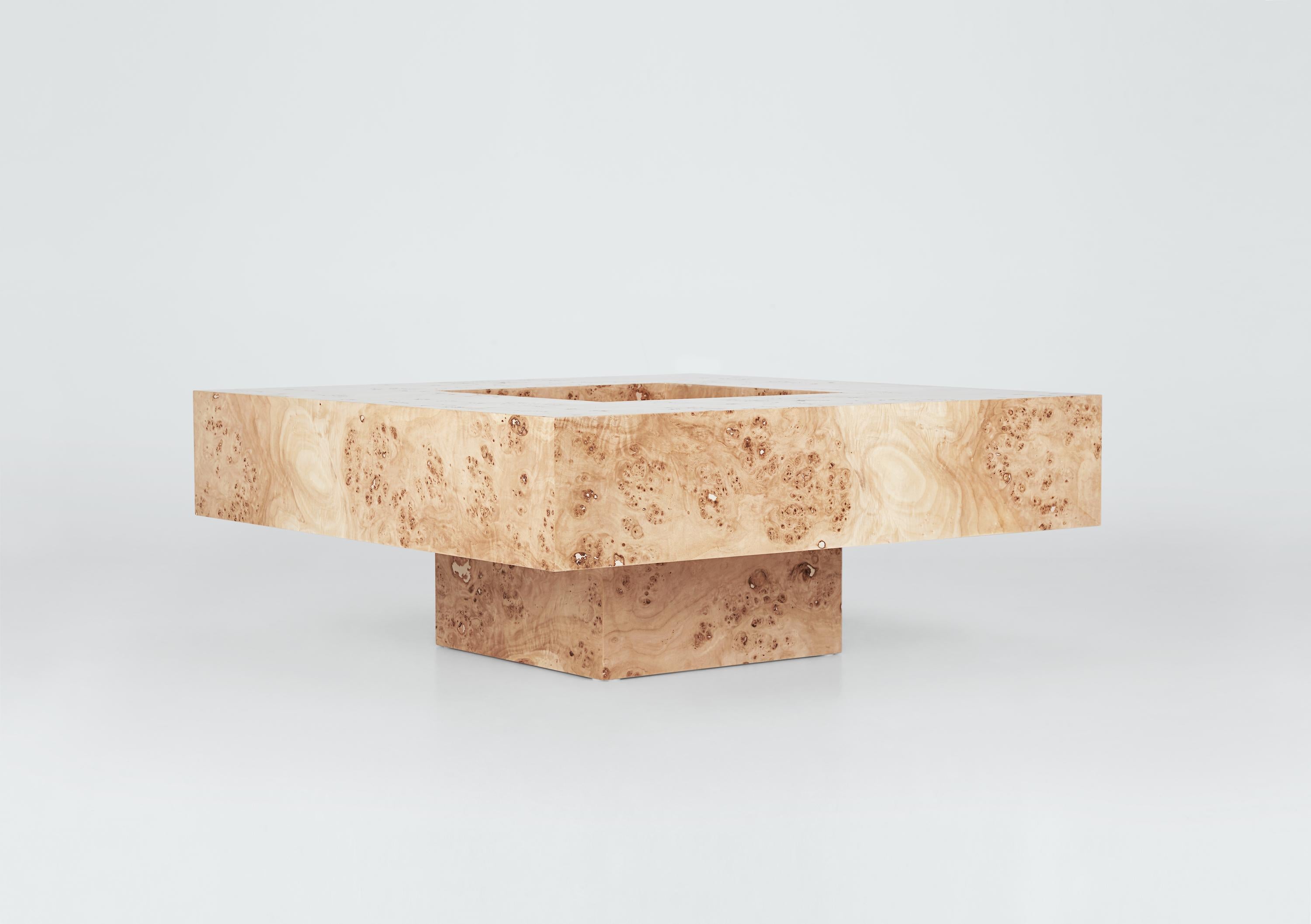 Elevate the ambiance of your home with the exquisite charm of this luxurious poplar burl coffee table. Handcrafted with meticulous precision and care by expert artisans in Portugal, this one-of-a-kind table is a testament to timeless beauty and