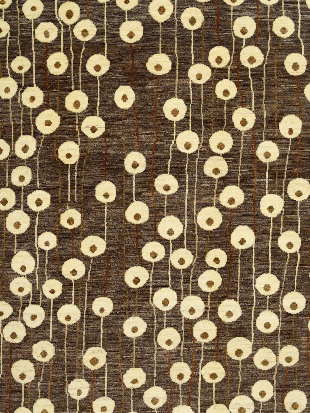 Featuring harmonious shades of neutral brown, cream, and taupe wool, Poppies from the Orley Shabahang Art Deco collection consists of a hand-knotted pure wool pile, cotton warp, and woolen weft. Measuring 6’ x 8’10”, this carpet showcases a field of