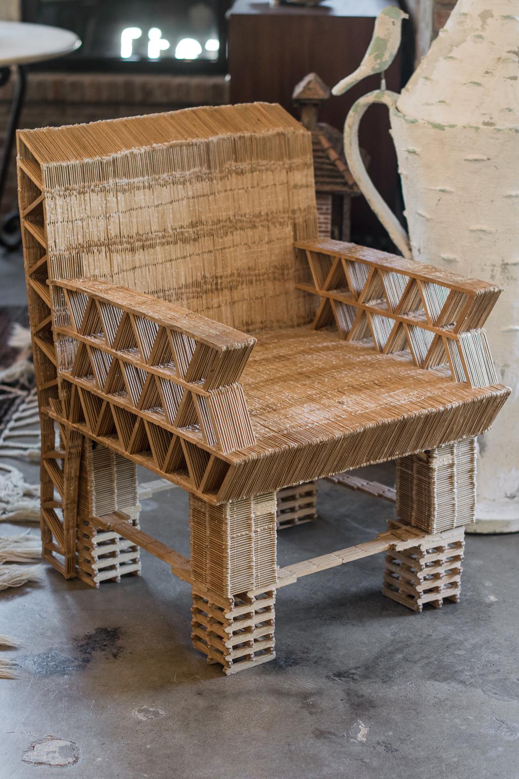 In a modern expression of tramp art, the crafter used popsicle sticks and glue to make functional art. Generously scaled chair that is more comfortable than expected. 20th century.