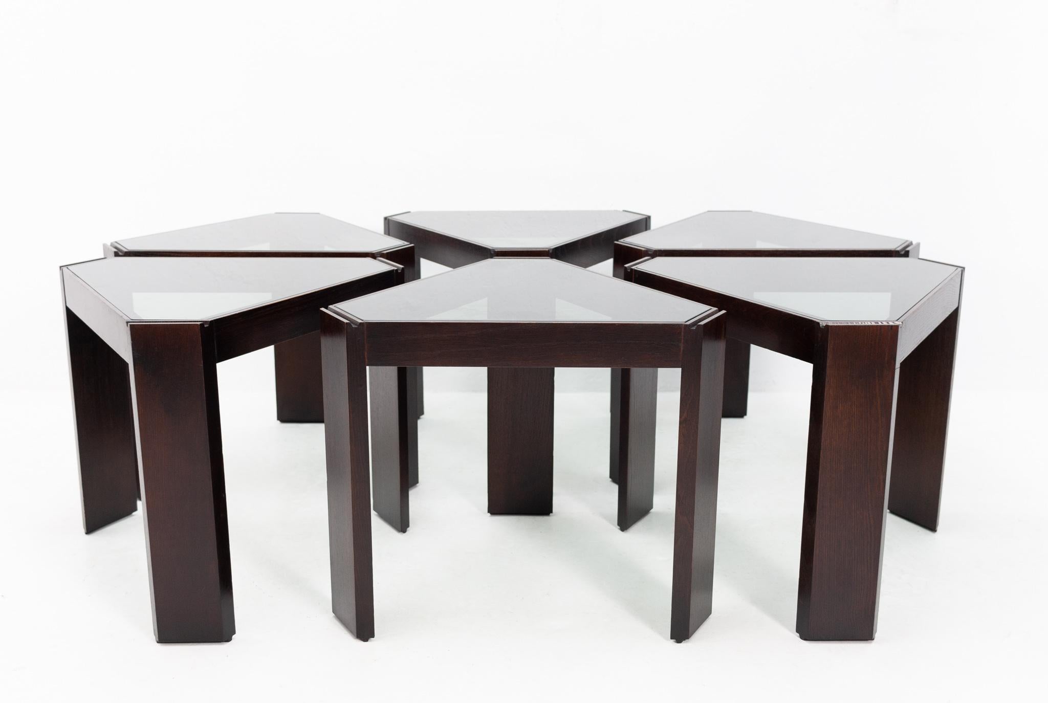 These six stacking tables were made by Porada Arredi in Italy, 1970s they can be arranged in many different ways. The frames are made of dark walnut wood and the tops of smoked glass. Very good condition. Complete set of six.
 