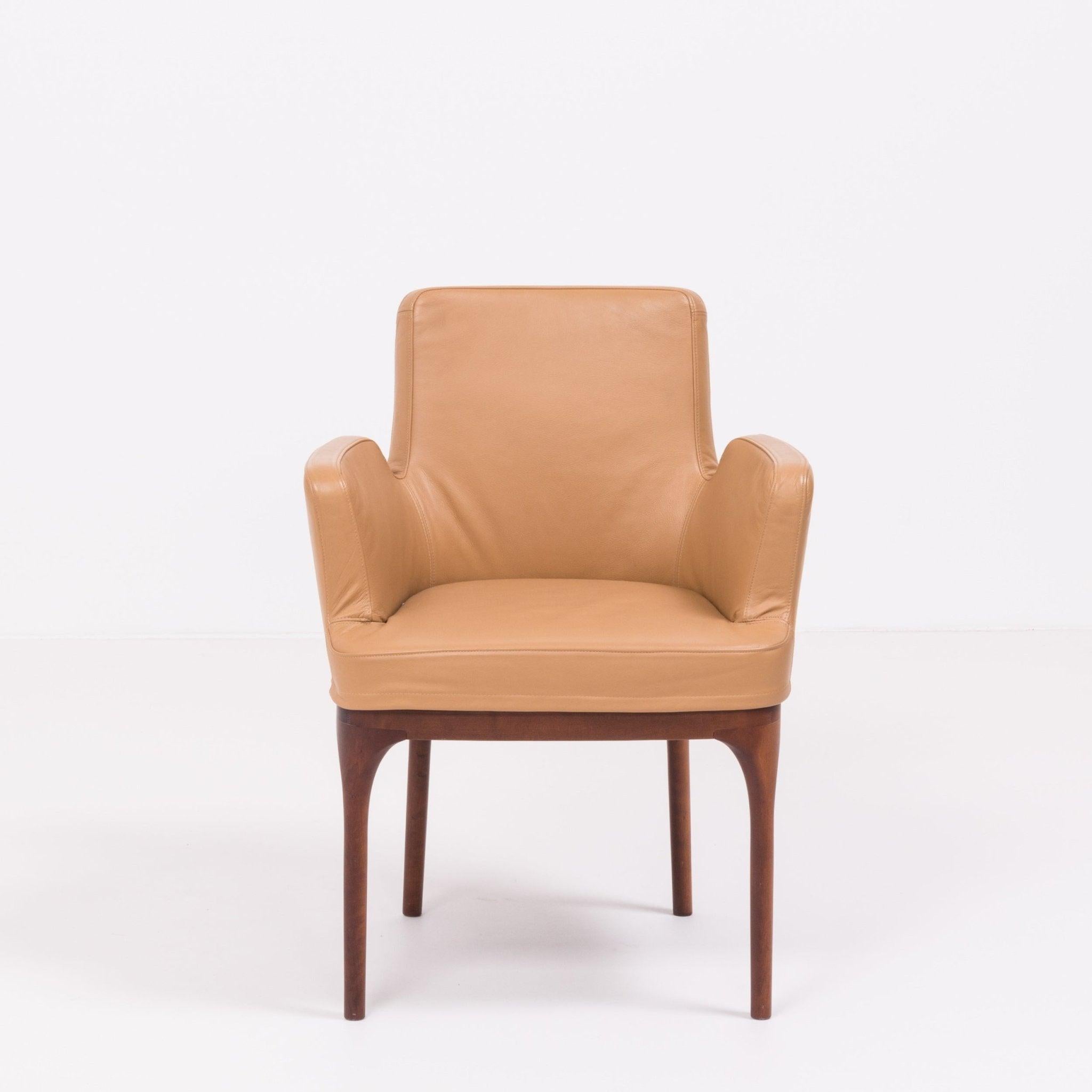 Introducing the epitome of luxury and style - the Porada Armchair. Crafted with the finest materials and impeccable attention to detail, this armchair exuded elegance and sophistication. The sleek and modern design, combined with the warm tones of
