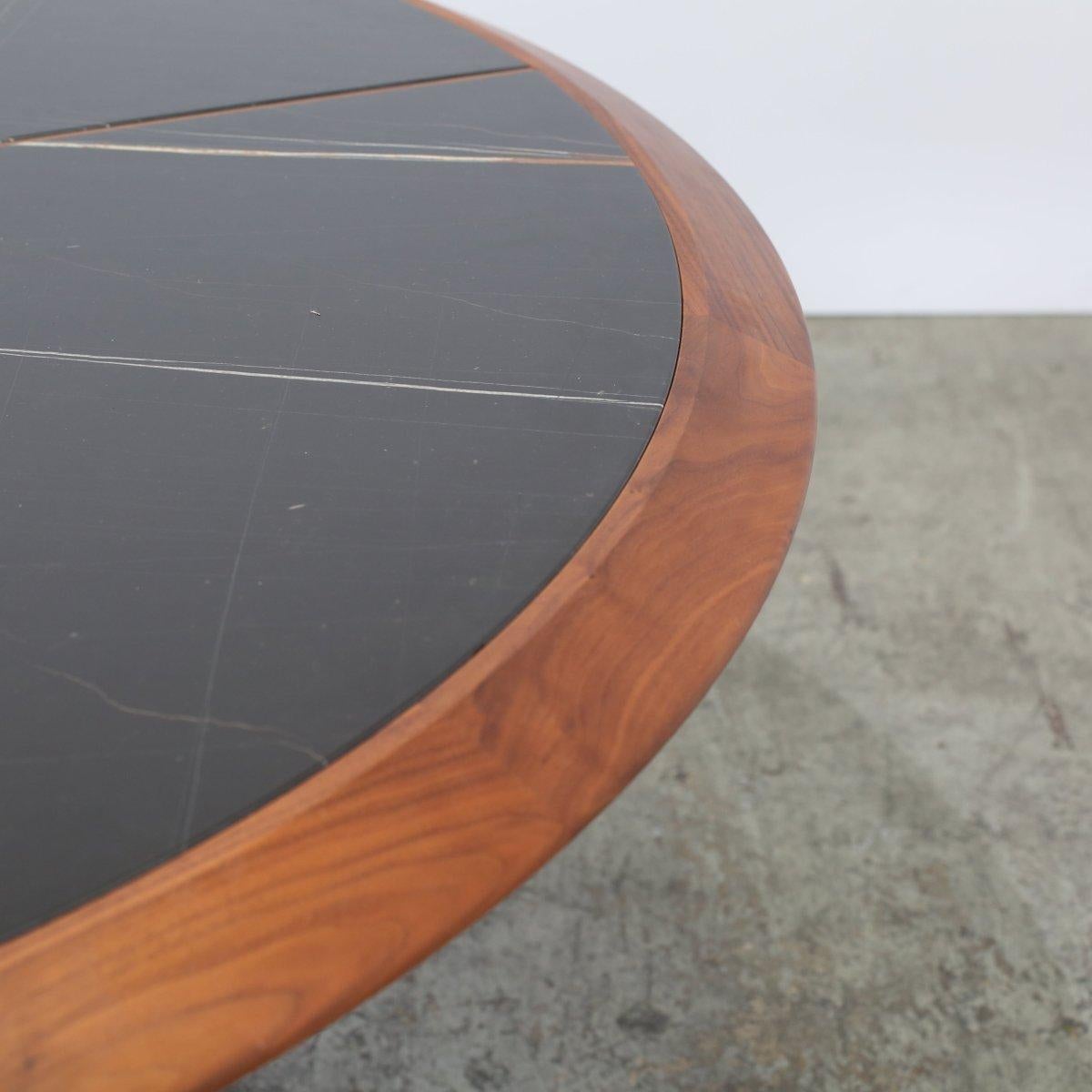 Introducing the Thayl Dining table by Porada, a stunning addition to any luxury dining space. Crafted with high quality materials, this table boasts a sleek and modern design, featuring a solid wood base and a striking marble top. The unique shape