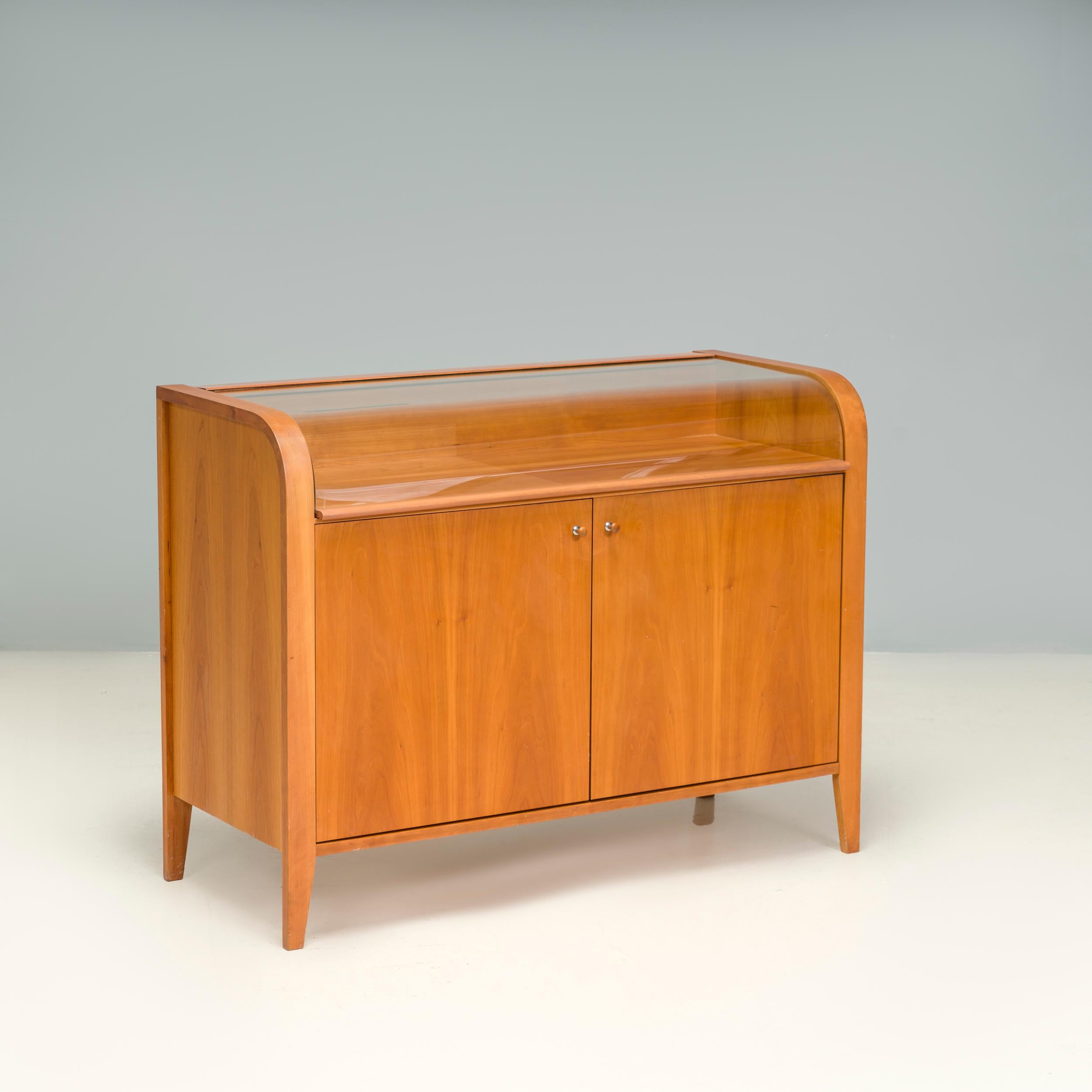 Beautifully constructed by Porada in Italy, this vitrine style sideboard perfectly balances practical storage with room to display treasured objet.

The sideboard is constructed from wood and sits on slimline tapered legs. The front features two
