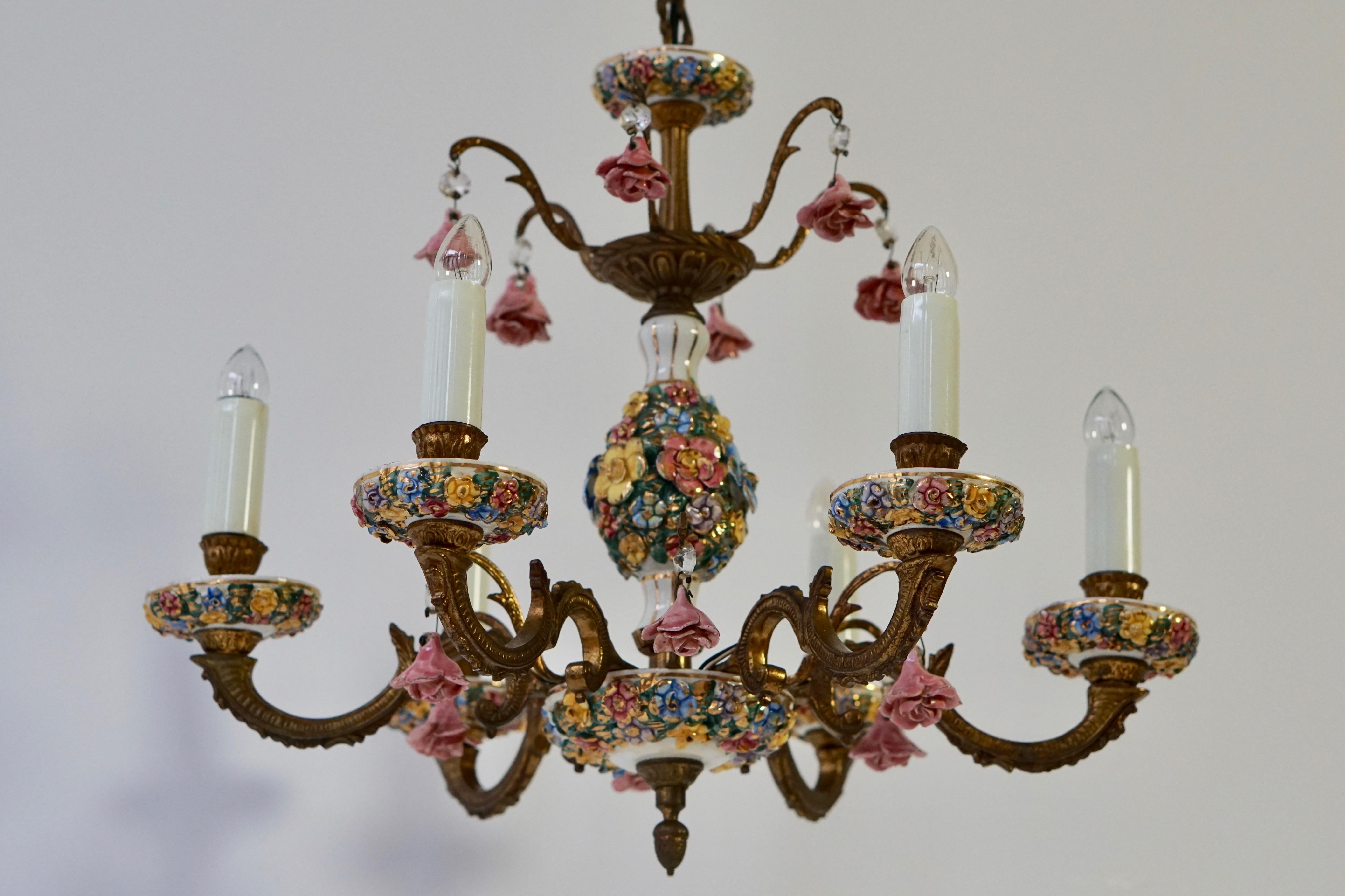 Mid-20th century brass chandelier decorated with flowers. Crafted in the Rococo style, the mounts and the six-armed light are a symphony of flowers and flourishes in Meissen taste, circa 1960s-1970s.
Dimensions: Diameter 46 cm. Height fixture 44