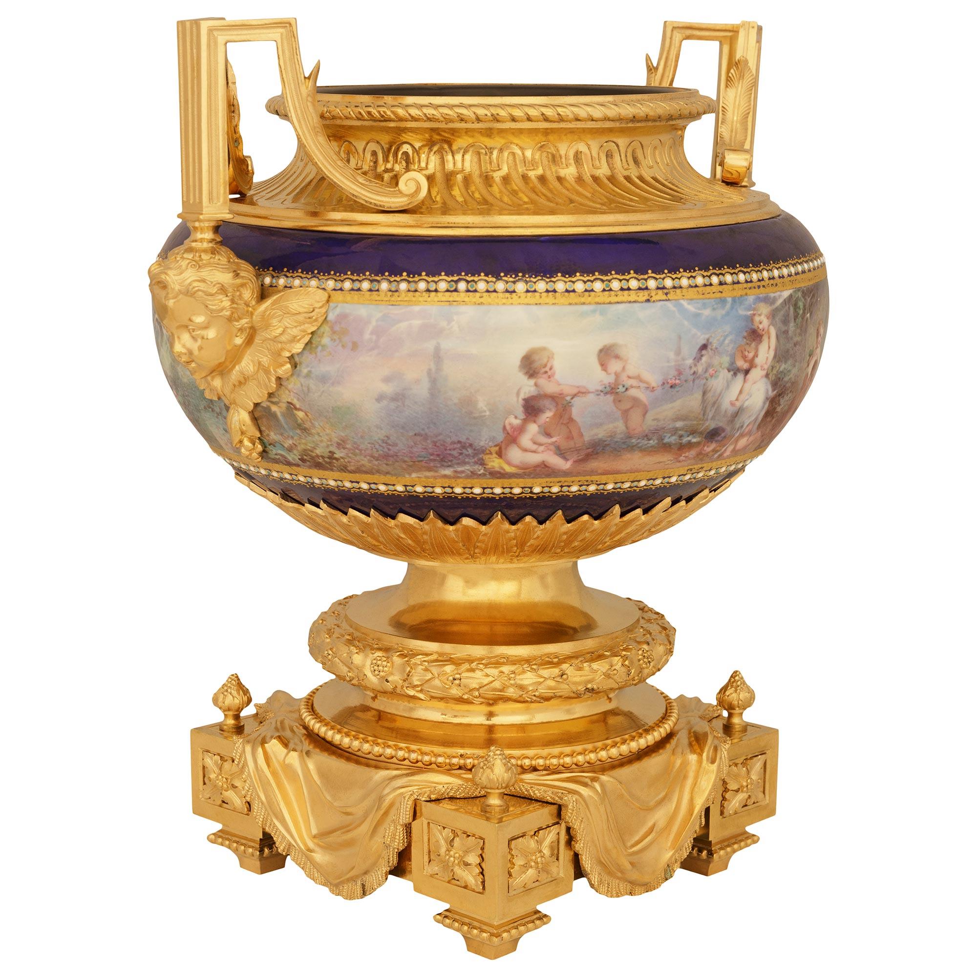 A striking and high quality French 19th century Louis XVI st. Porcelain and Ormolu centerpiece planter, attributed to Henri Picard. This stunning enameled Porcelain centerpiece is raised on an exceptional and richly detailed square Ormolu base with