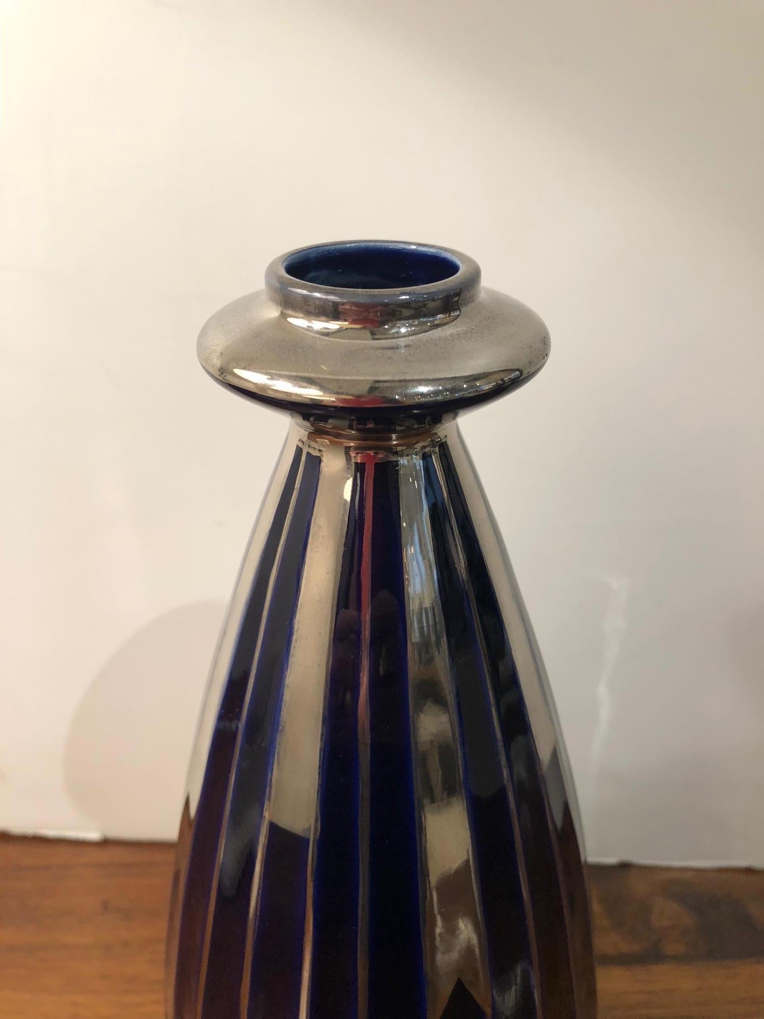Signed porcelain navy blue and silver Art Deco faceted vase.

Available to see in our NYC Showroom 
BK Antiques
306 East 61st St. 2nd fl.
New York, NY 10065