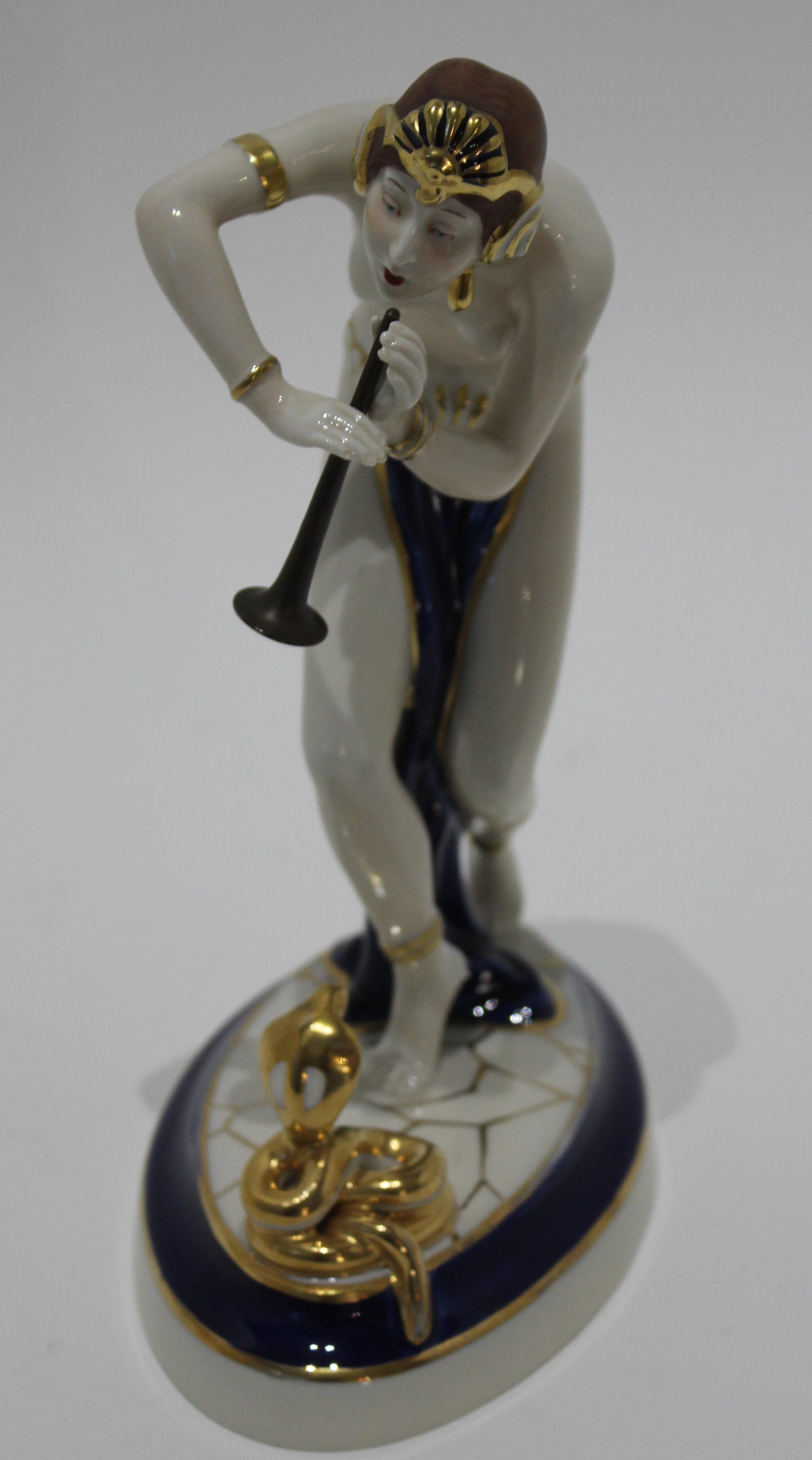 Porcelain Art Deco 1920s-1930s snake charmer figurine with old style horn royal Cux Czech tags signatures

Art Deco 1920s-30s snake charmer figurine with old style horn Royal Dux Czech tags signatures from a Palm Beach estate. This is more refined