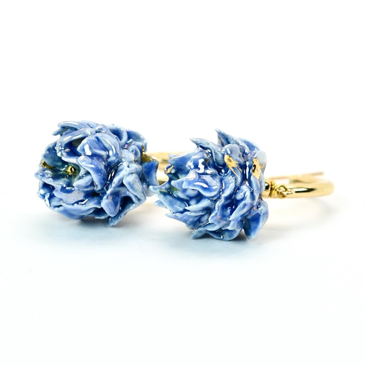 Porcelain  24K gold Mother of pearl  Handmade in London 

Add a stunning touch of nature to your look with our CAMPANA Porcelain Earrings. Their unique design resembling closed artichoke flower is elegantly finished in an eye-catching blue color,