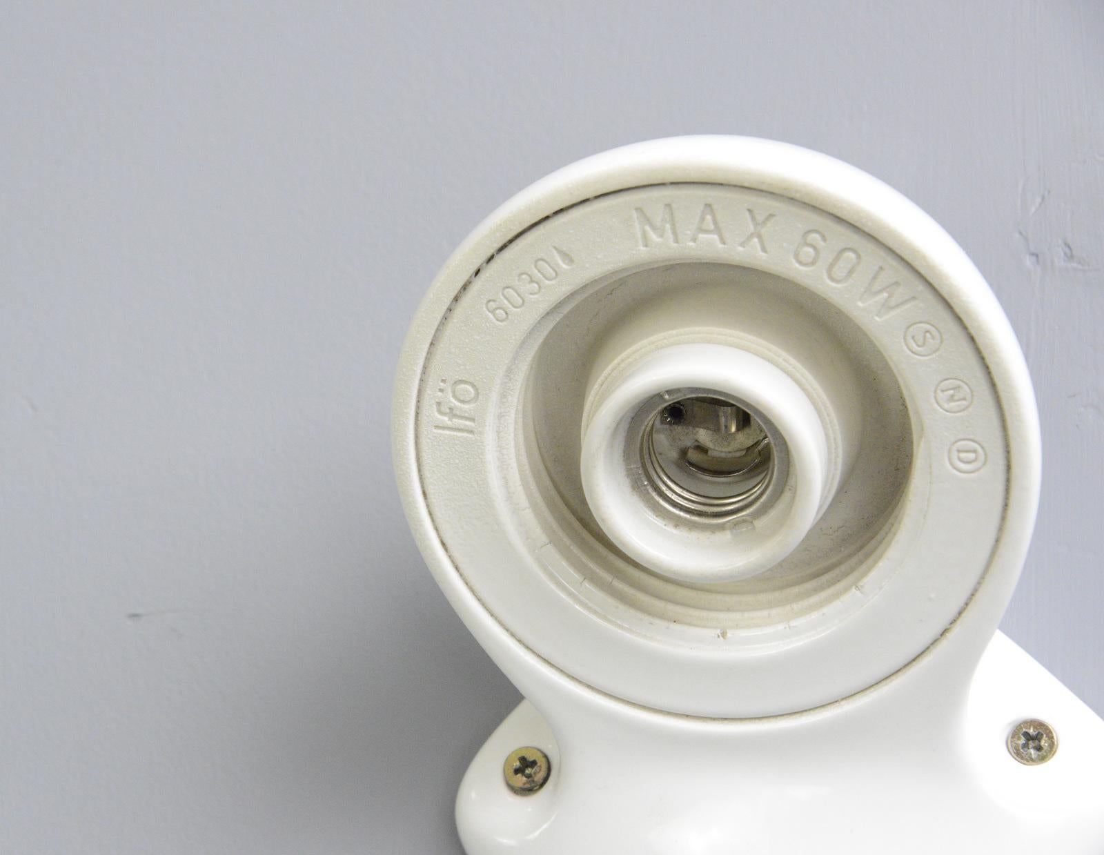 Porcelain bathroom lights by Sigvard Bernadotte for Ifo, circa 1950s

- Price is for the pair
- Vitreous white porcelain wall mounts
- Screw off opaline shades
- Takes E27 fitting bulbs
- Wires directly into the wall
- Designed by Sigvard