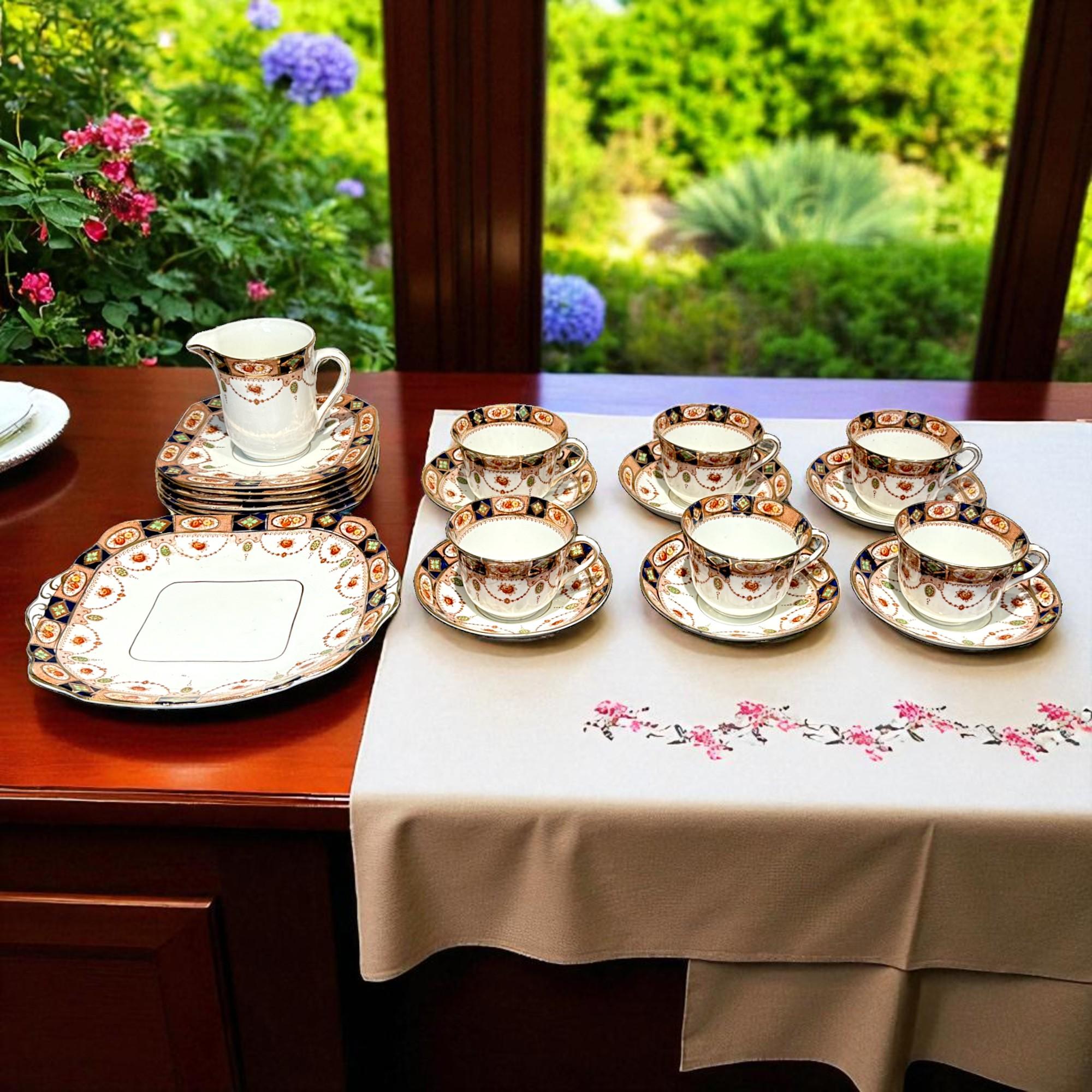 Charming tea service in the purest English tradition, hand-painted in England, Best Bone China G&H.L, n°1118 pattern. 
It includes six cups and saucers, six dessert plates, a milk jug and 1 cake plate.

It showcases a vibrant and ornate design,