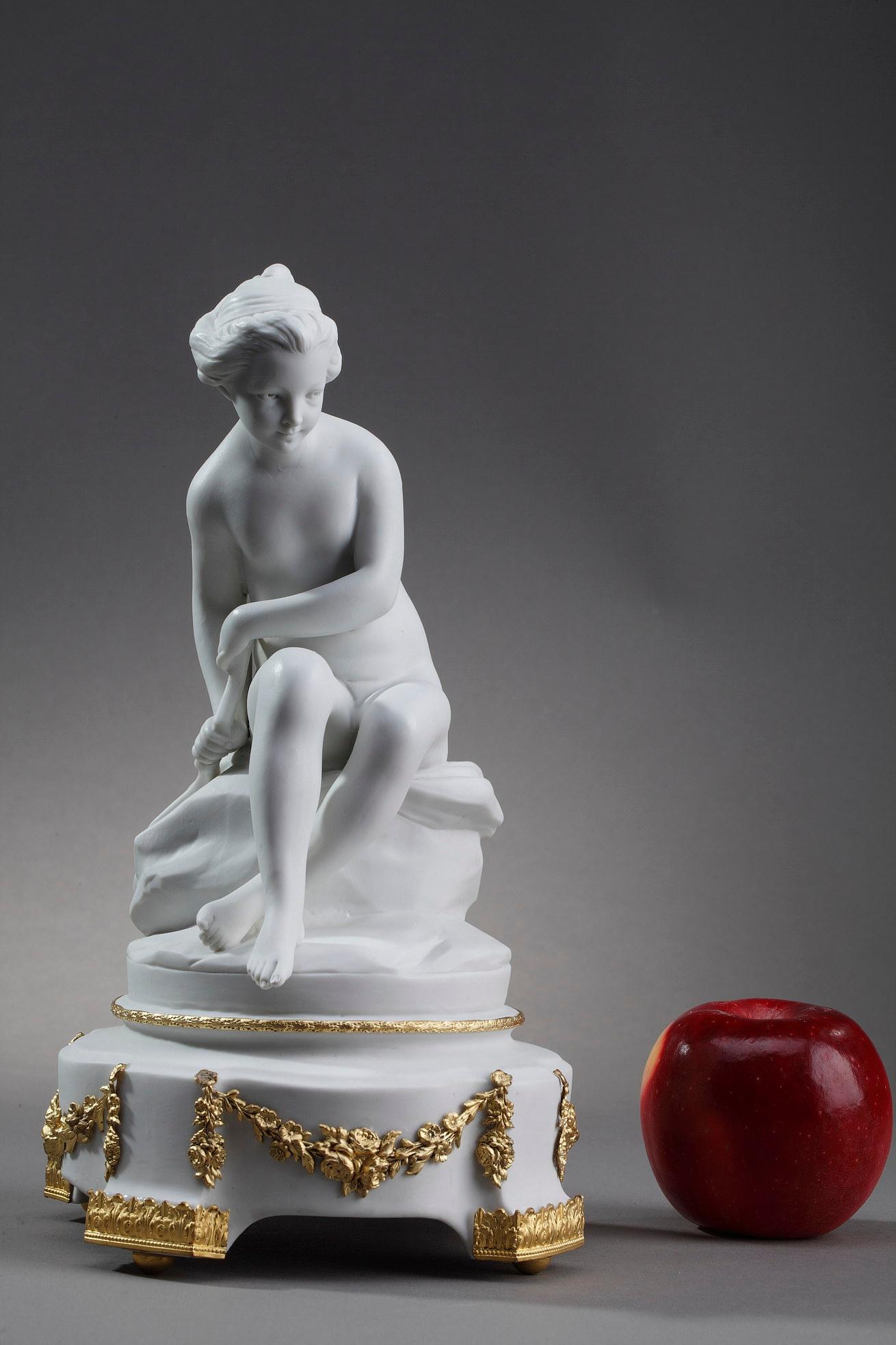 Statuette in bisque porcelain of the Rudolstadt-Volkstedt factory representing Psyche as a small girl hiding the bow of Cupid. Her hair is raised in a bun. The eyes with hollowed out pupils show the ingenuity of Etienne-Maurice Falconnet to give
