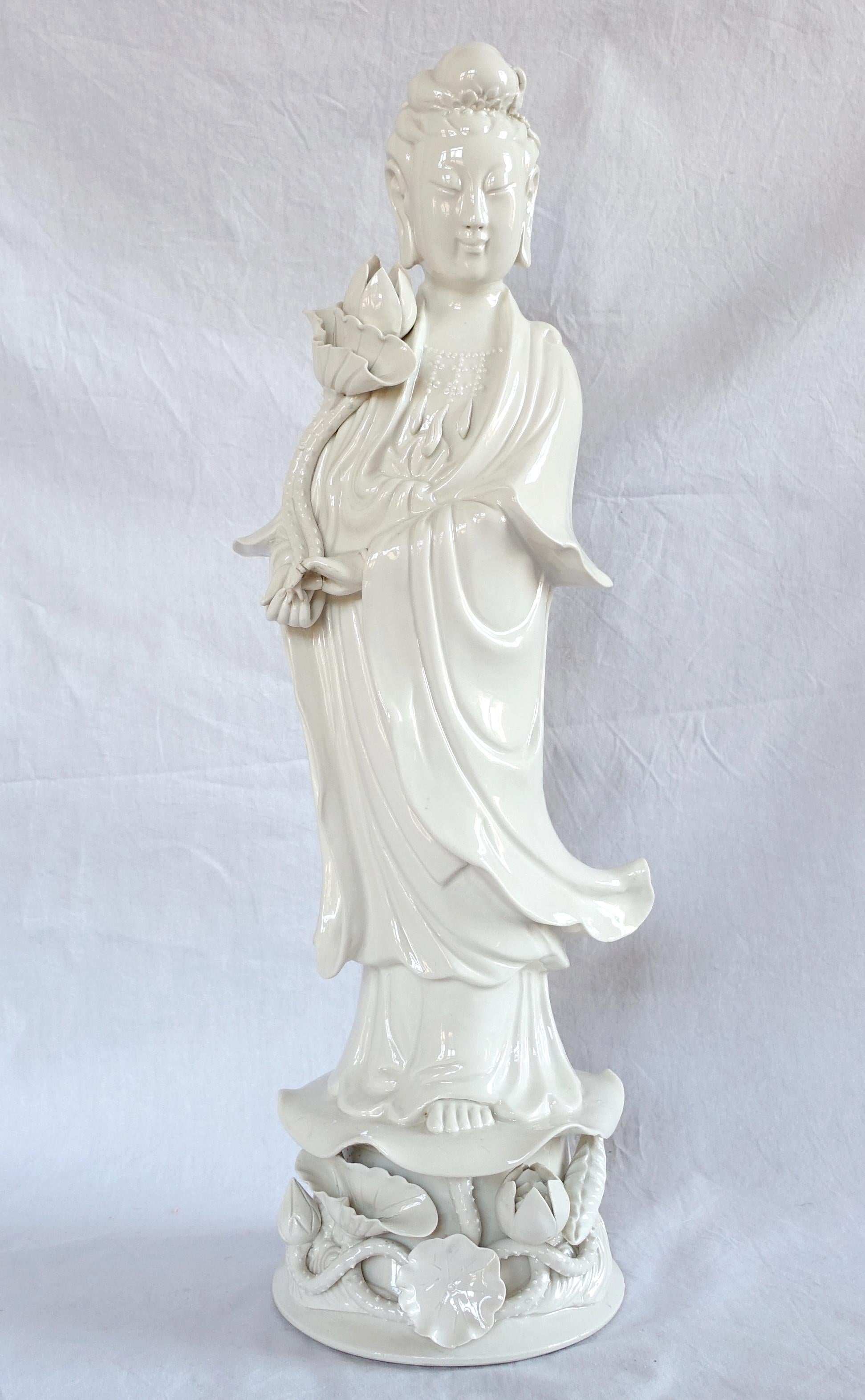 A porcelain Blanc de Chine Guanyin statue standing on a fine lotus flowers and leaves decoration ; China circa 1900. This is a tall piece to place on a large mantel or a commode, the sculpture is thorough.
A mark under the base.
Ideal to complete a