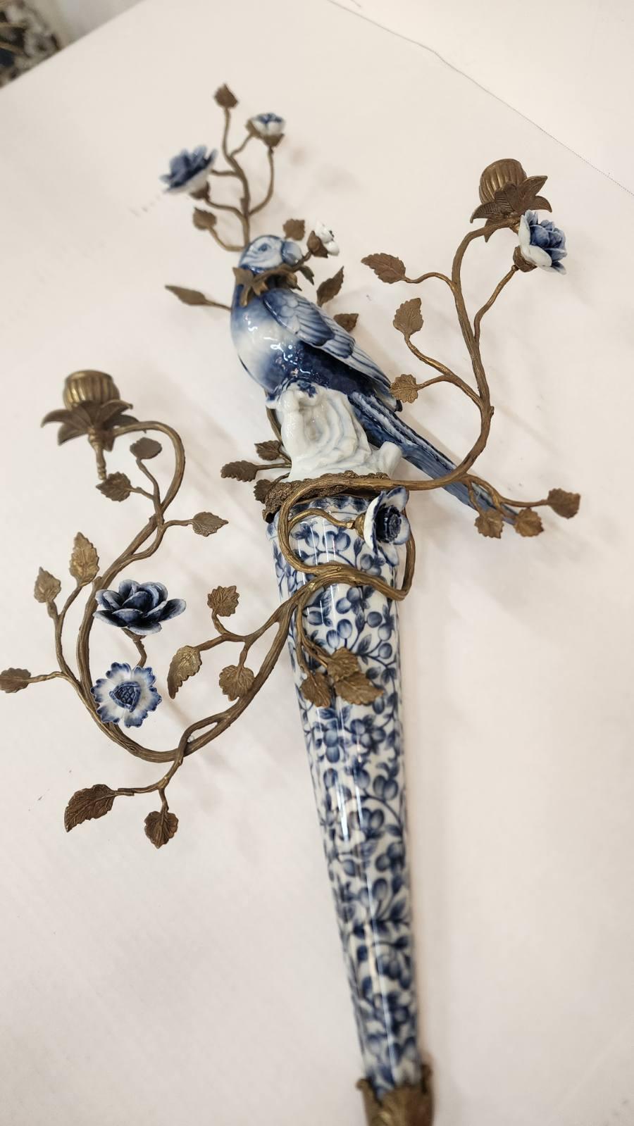 In the style of Castilian. Porcelain Birds blue and white figural sconces with gilt metal and bronze porcelain floral accents. 