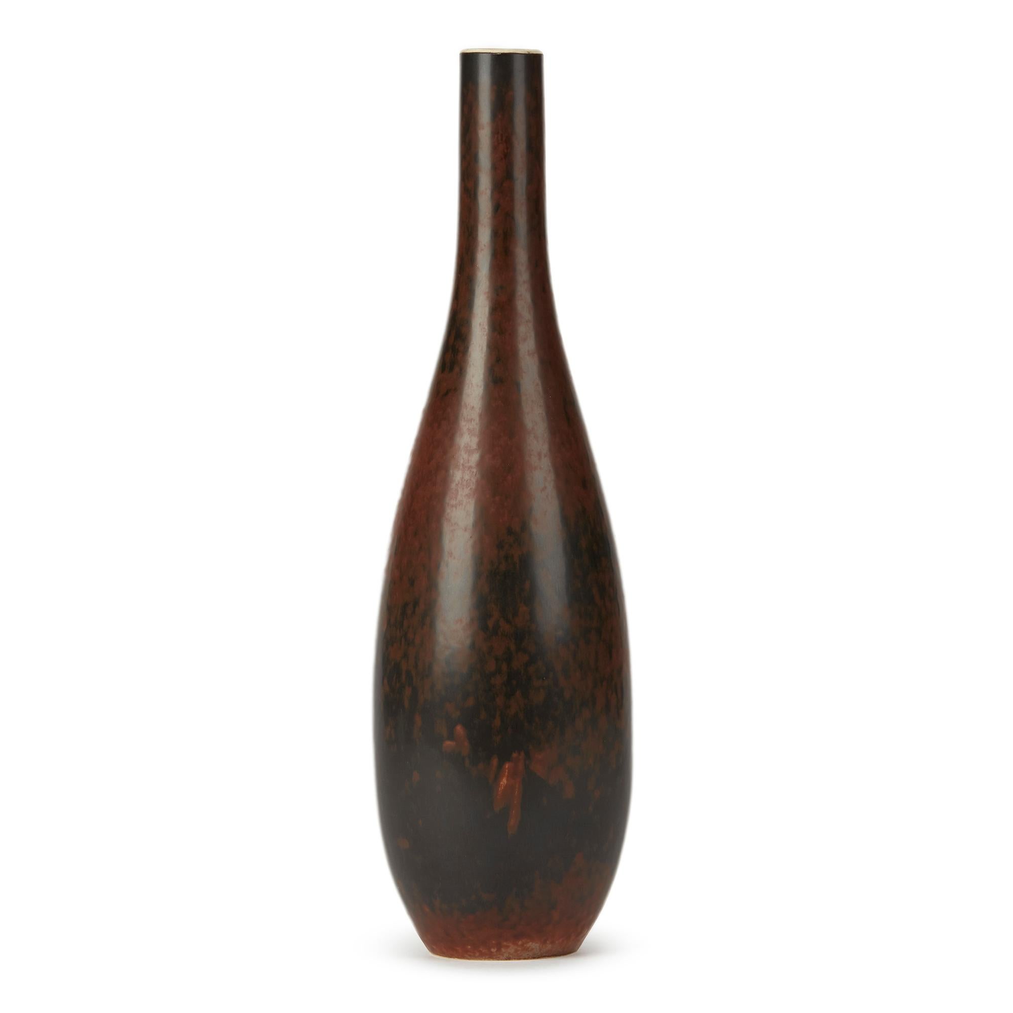 A stylish vintage Swedish art pottery bottle shaped vase designed by Carl Harry Ståhlane (1920-90) for Rörstrand. The porcelain bodied vase is of elegant rounded shape graduating to a narrow funnel shaped neck is decorated in mottled brown glazes.