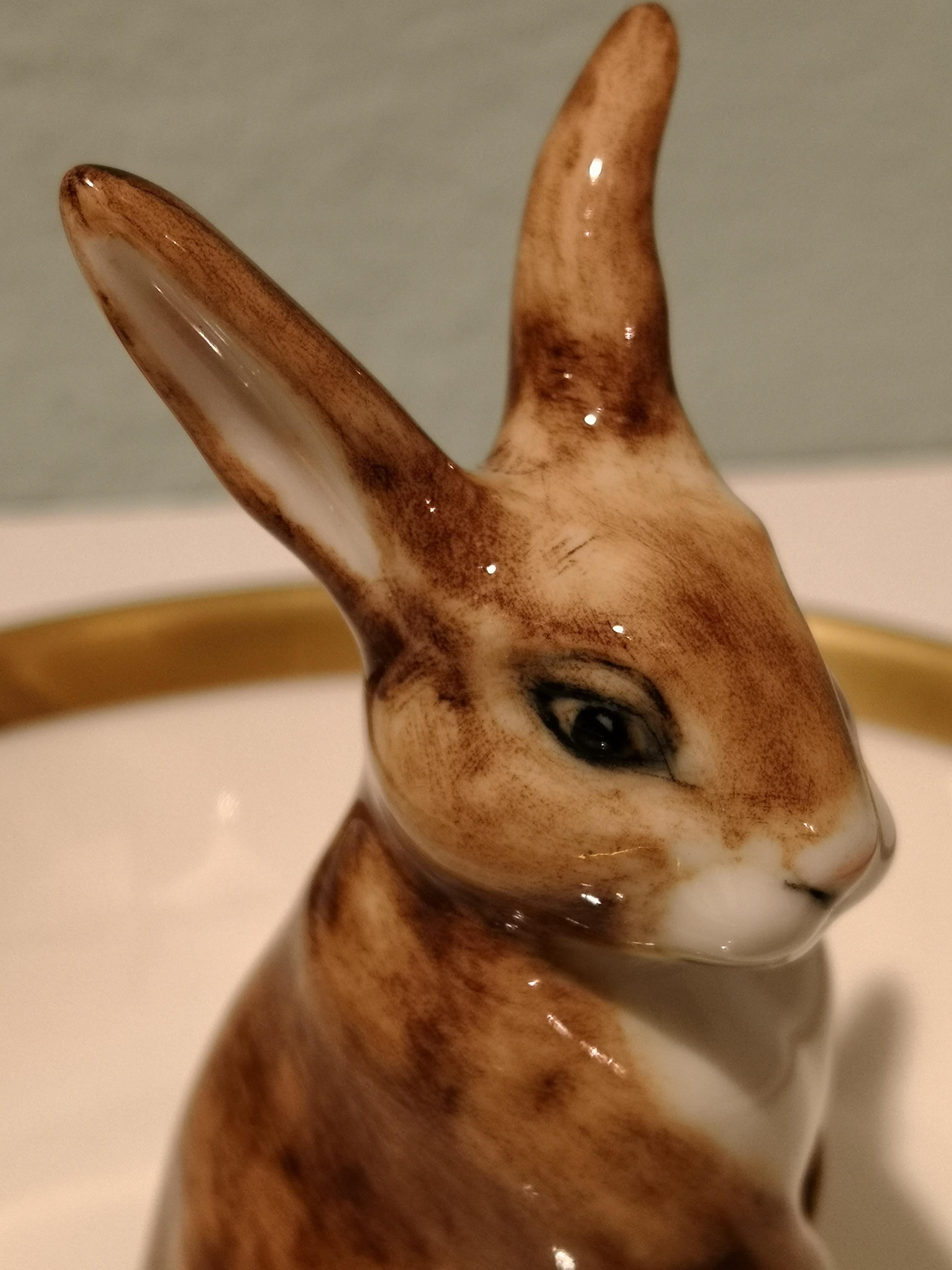 Entirely handmade porcelain bowl with a hands-free naturalistic formed Easter rabbit in brown and white colors. The rabbit is sitting in the middle of the bowl for decorating nuts or sweets around the figure. Rimmed with a fine 24-carat gold line.