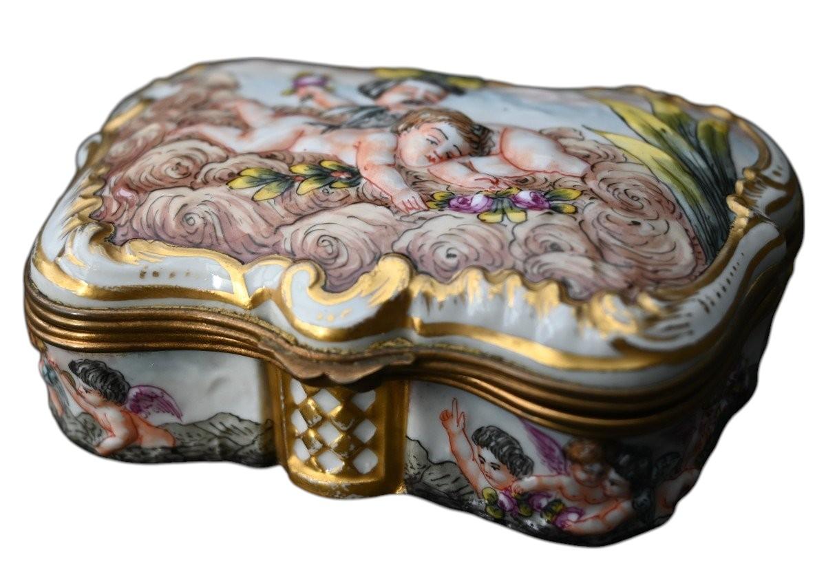 Precioso joyero antiguo de porcelana de Capodimonte del siglo XIX con decoración en altorrelieve y pintada a mano y marco de bronce dorado 10,5 x 7,5 cm, altura 3,4 cm Perfecto estado, sin astillas, grietas ni restauraciones