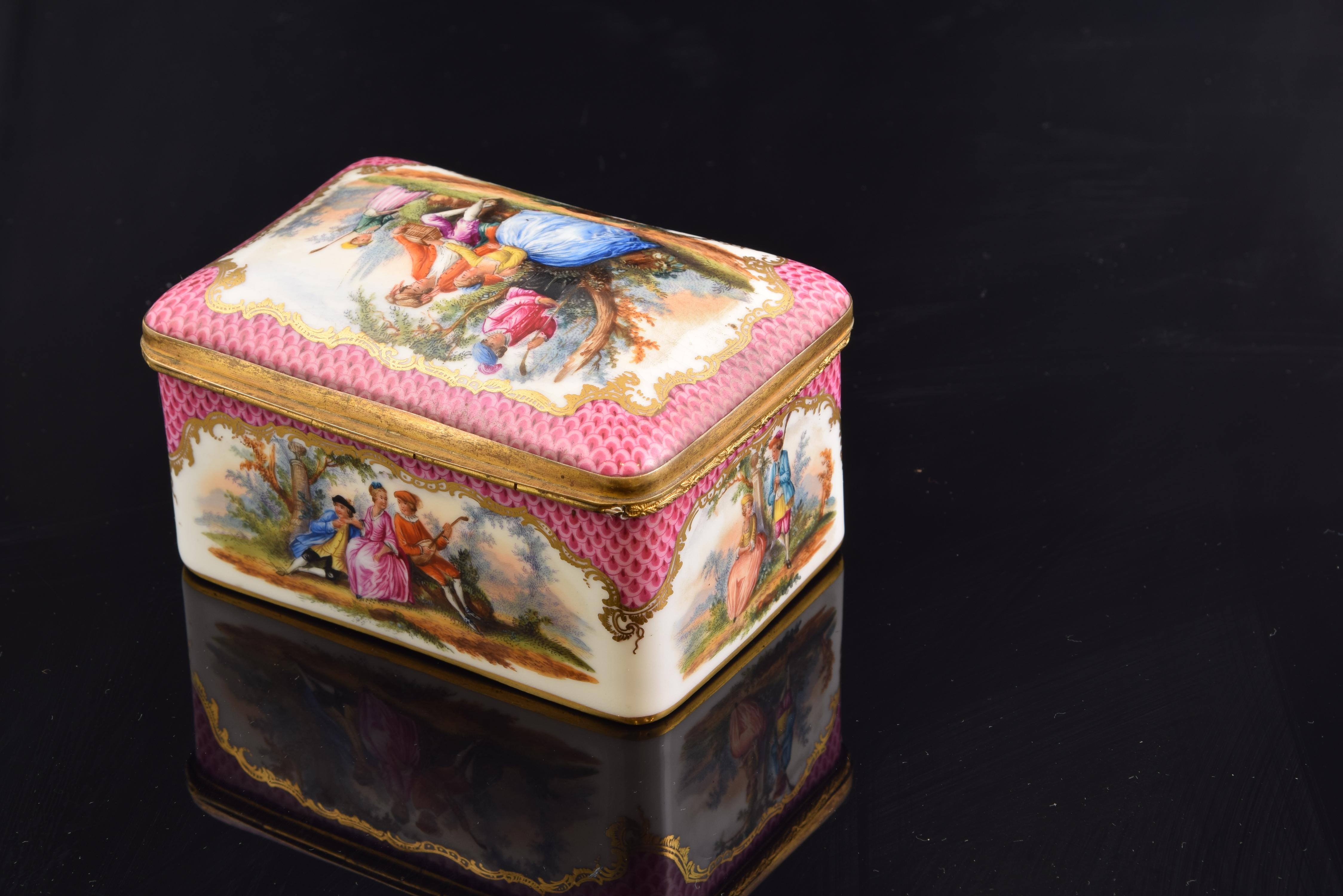Potschappel-Dresden, Germany, 19th century.
With brand on the base.
Rectangular box with a slightly curved lid made of enamelled porcelain with golden metal finishes and hinges that is decorated, on the outside, of figurative scenes of couples in