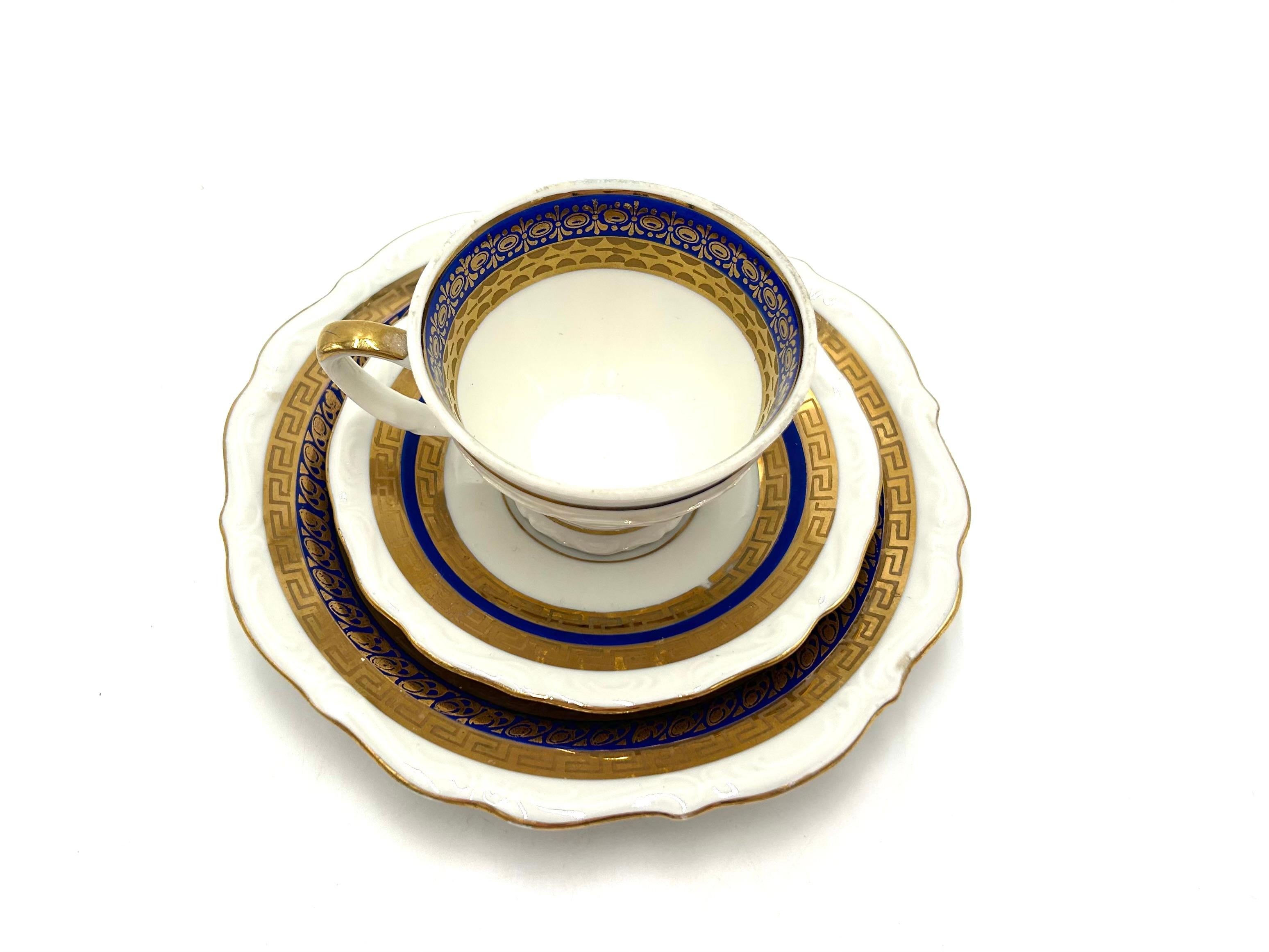 Porcelain trio - cup, saucer and plate

Decorated in gold and cobalt colors.

Produced by Bogucice in Poland in the 1960s.

cup: height 7.5 cm, diameter 4.5 cm.
