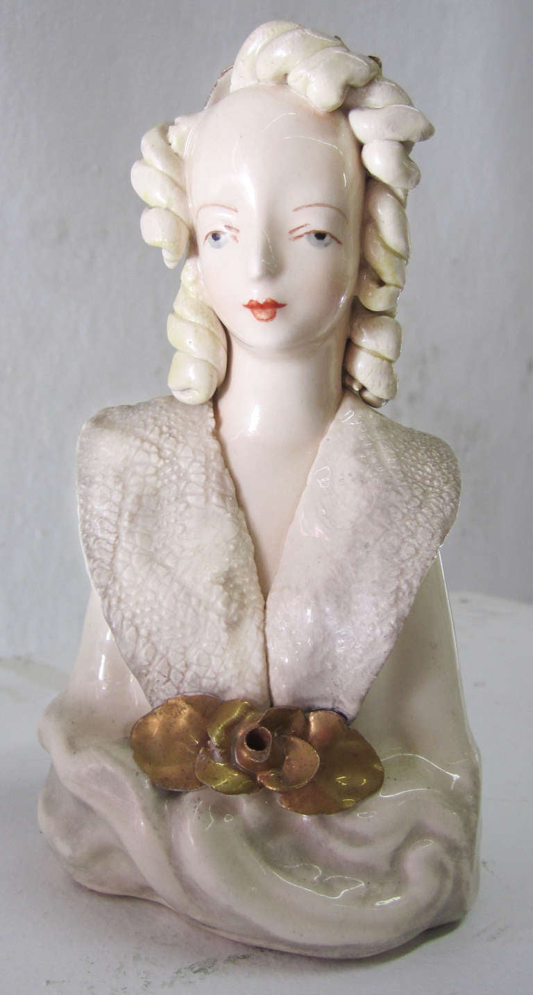 This petite bust of Victorian lady by Cordey was produced in the 1940s. The creamy porcelain woman features Fine hand painted details in her face and throughout. She is decorated with hand-formed hair and collar; the roses are finished with gold