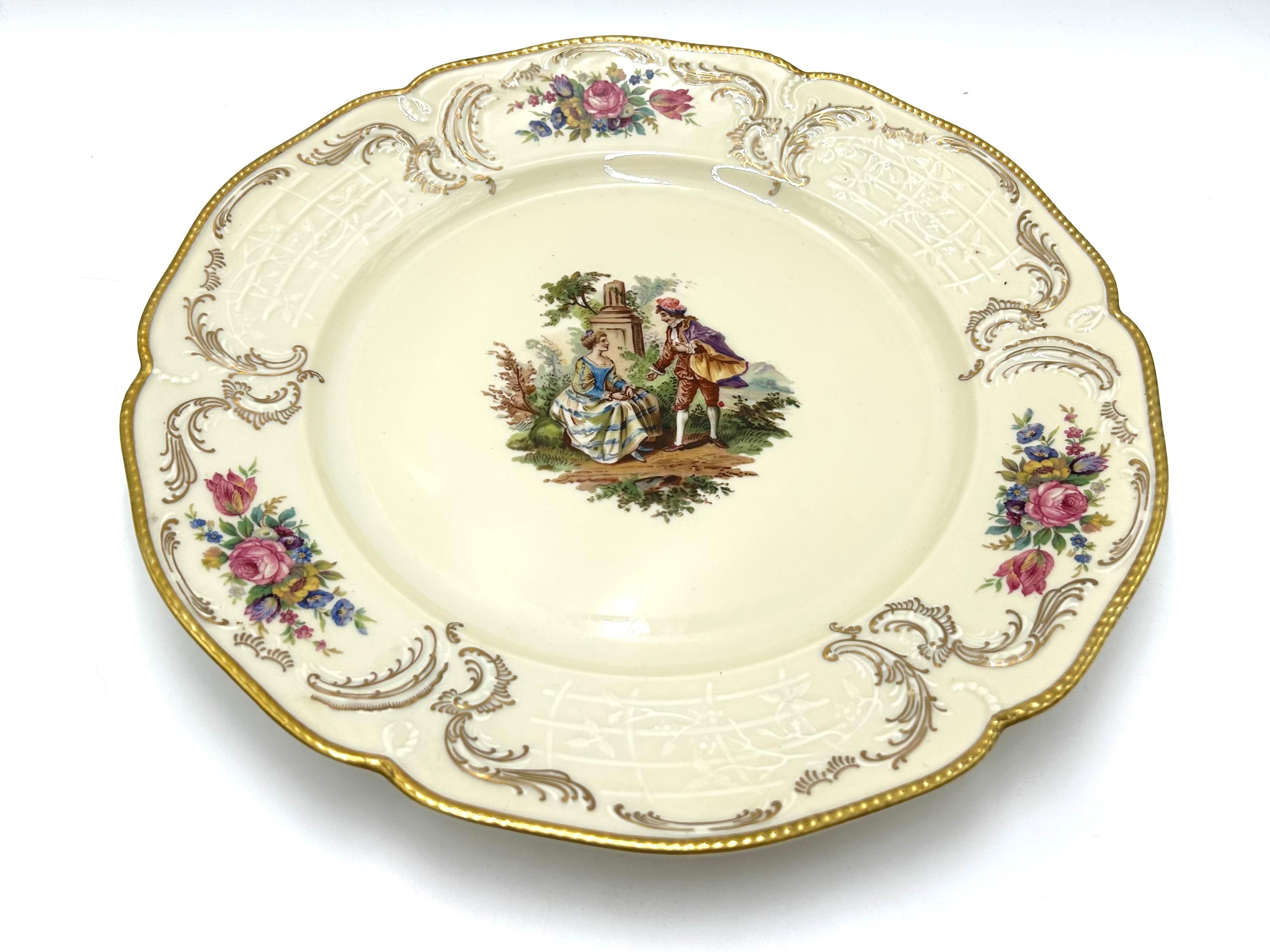 Porcelain plate, a product of the Sanssouci series of the valued German Rosenthal label.
Porcelain in ecru color, decorated with gilding, motif of floral bouquets and a genre scene. Signed with the mark of the manufacturer from 1946
Measures: