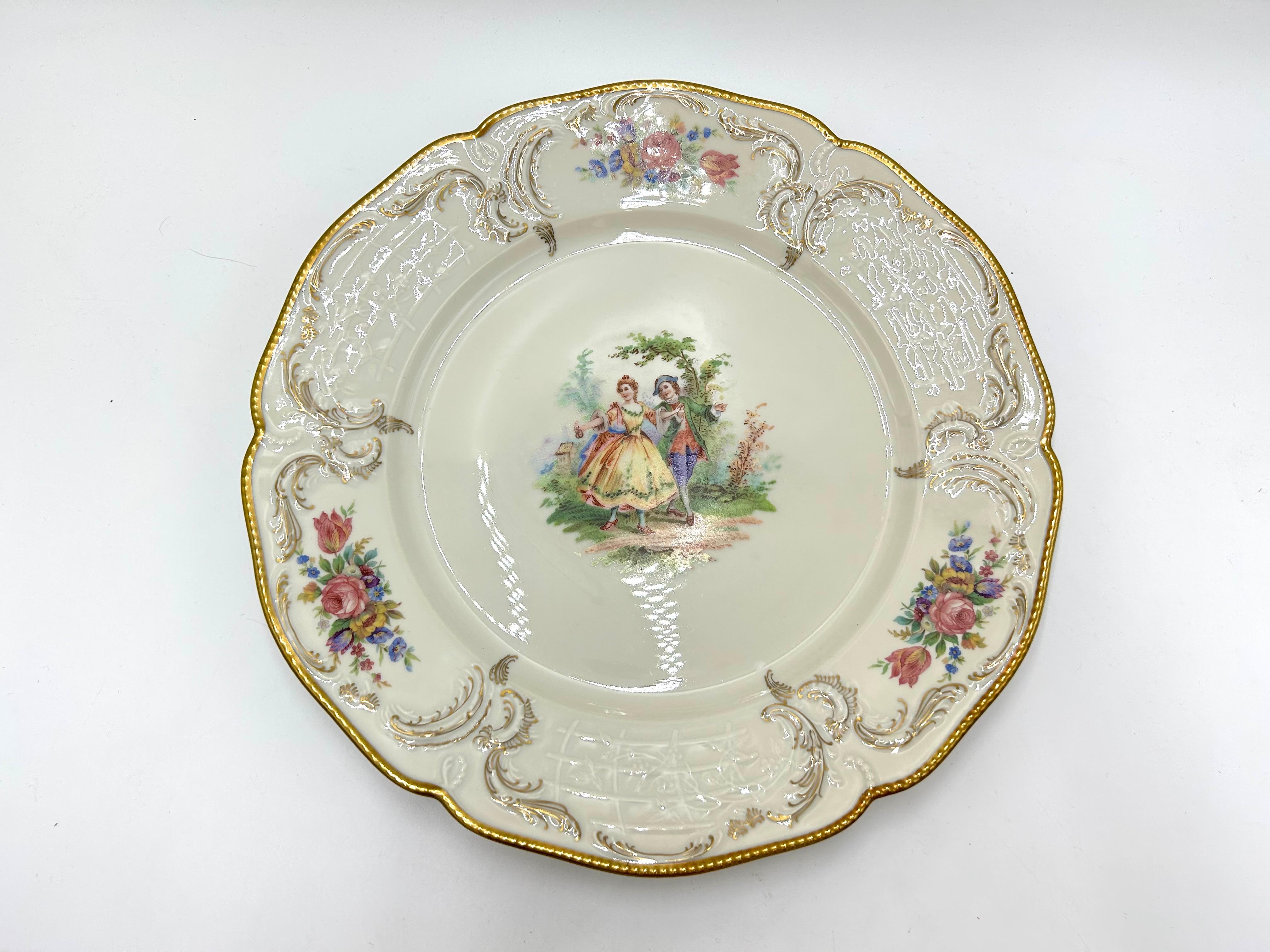 Porcelain plate, a product of the Sanssouci series of the valued German Rosenthal label.
Porcelain in ecru color, decorated with gilding, motif of floral bouquets and a genre scene.
Signed with the mark of the manufacturer from 1949.
diameter