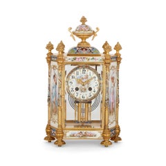 Pendule trois pièces en porcelaine, émail champlevé et bronze doré de style rococo