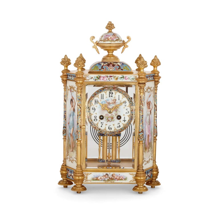 Porcelain, champlevé enamel, and gilt-bronze Rococo style three-piece clock set
French, Late 19th Century
Clock: height 38cm, width 23cm, depth 16cm
Vases: height 28cm, width 13cm, depth 10cm

This excellent three-piece set consists of a central