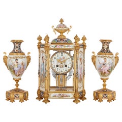 Porcelain, champlevé enamel, and gilt-bronze Rococo style three-piece clock set