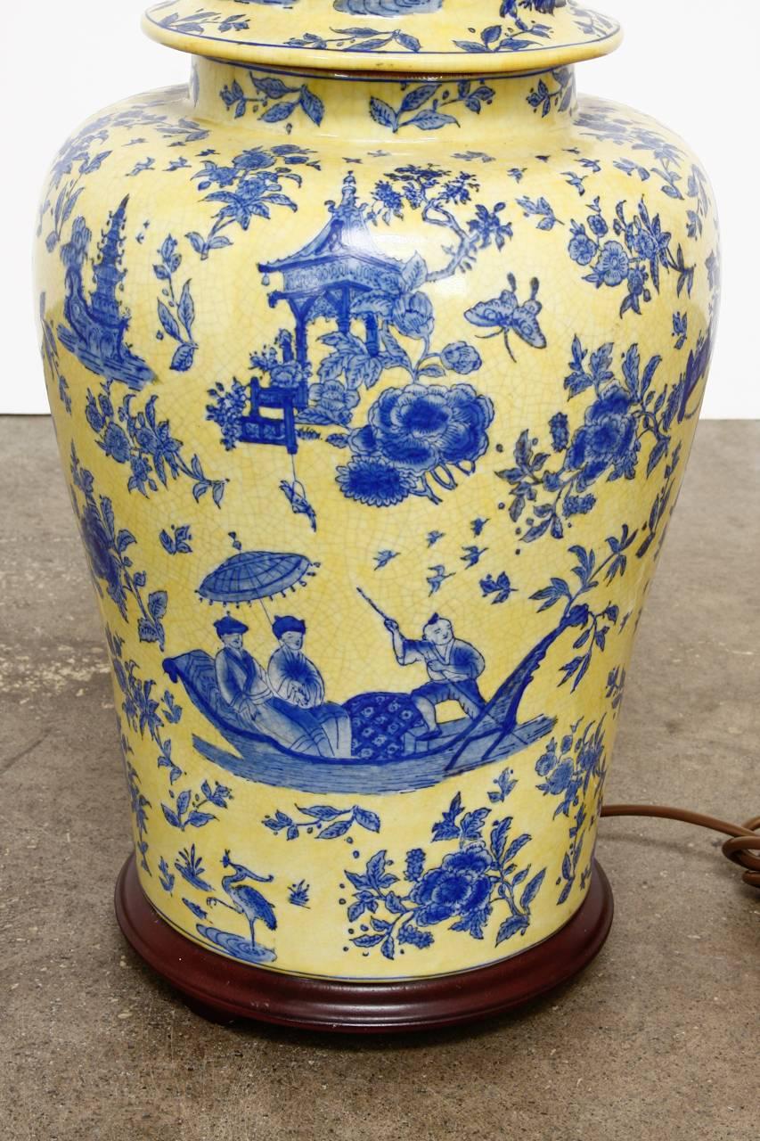 Stunning porcelain ginger jar table lamp made in the chinoiserie taste by Kinder-Harris. Features a vintage blue and yellow porcelain ginger jar craquelure finish mounted to a round wooden base. Topped with brass hardware and finial. Decorated with