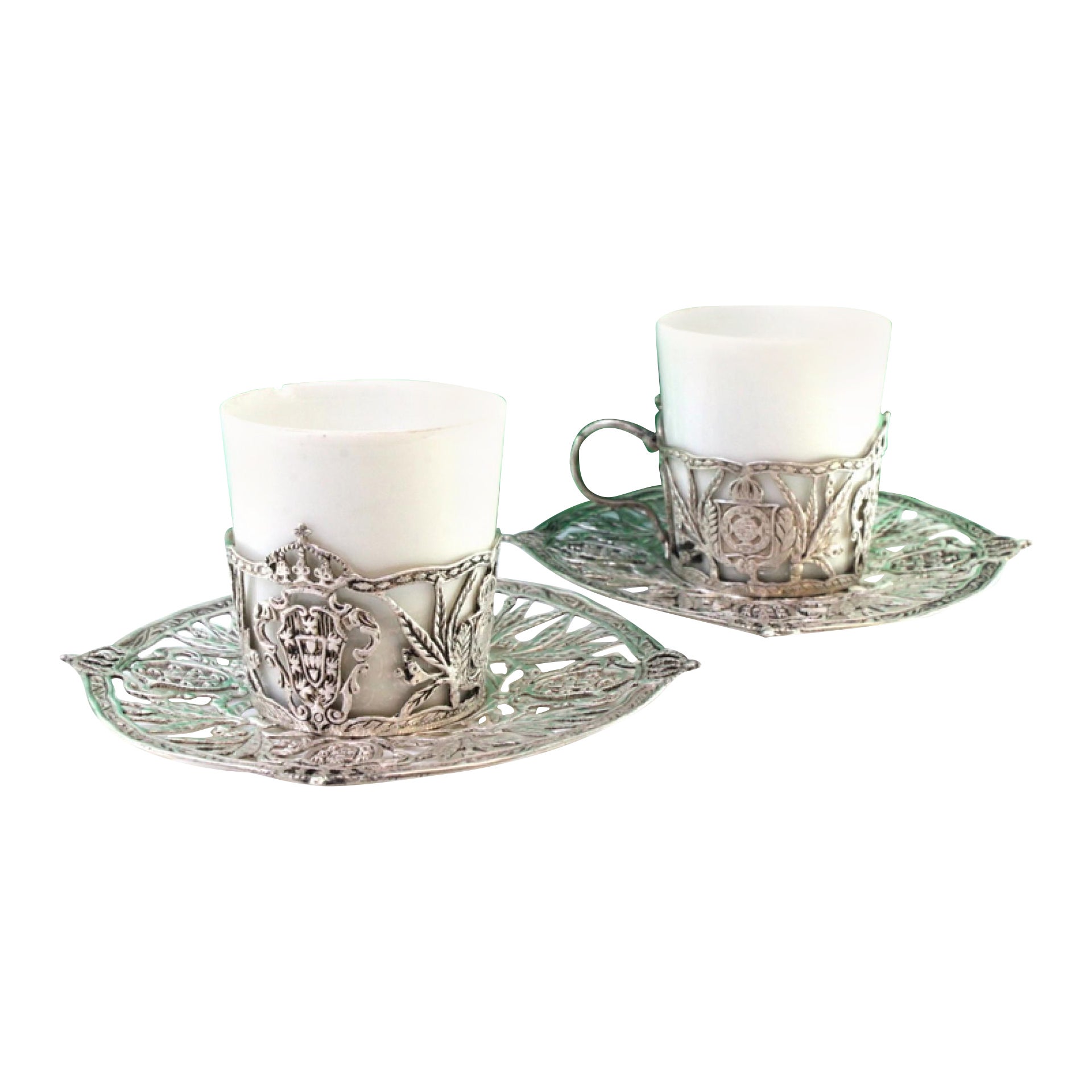 Porcelain coffee cups with silver stands featuring coats of arms and cutouts